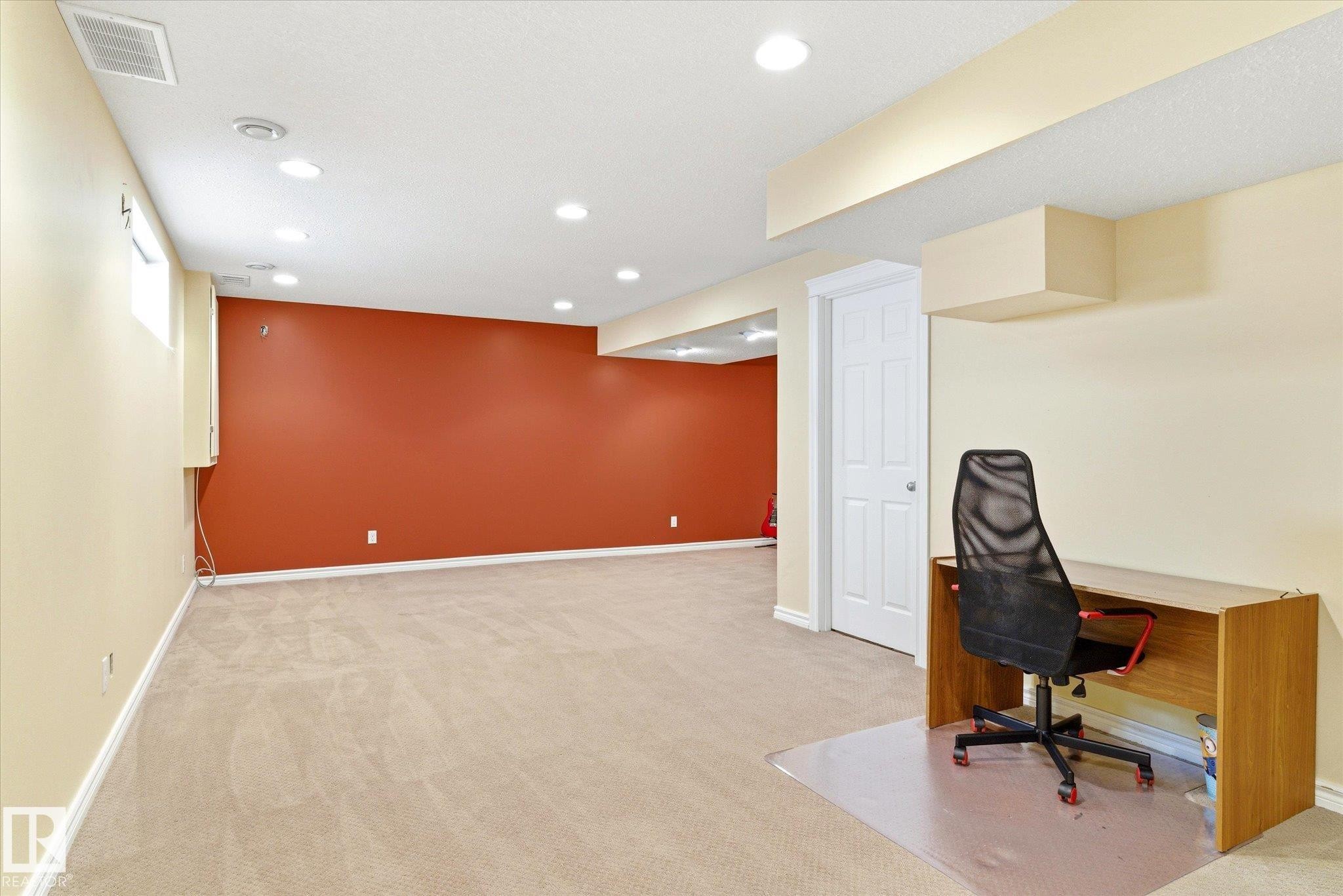 Recessed lighting, light-colored carpeting, white interior doors, and neutral wall finishes - 2550 Rabbit Hill Road Nw, Edmonton, AB