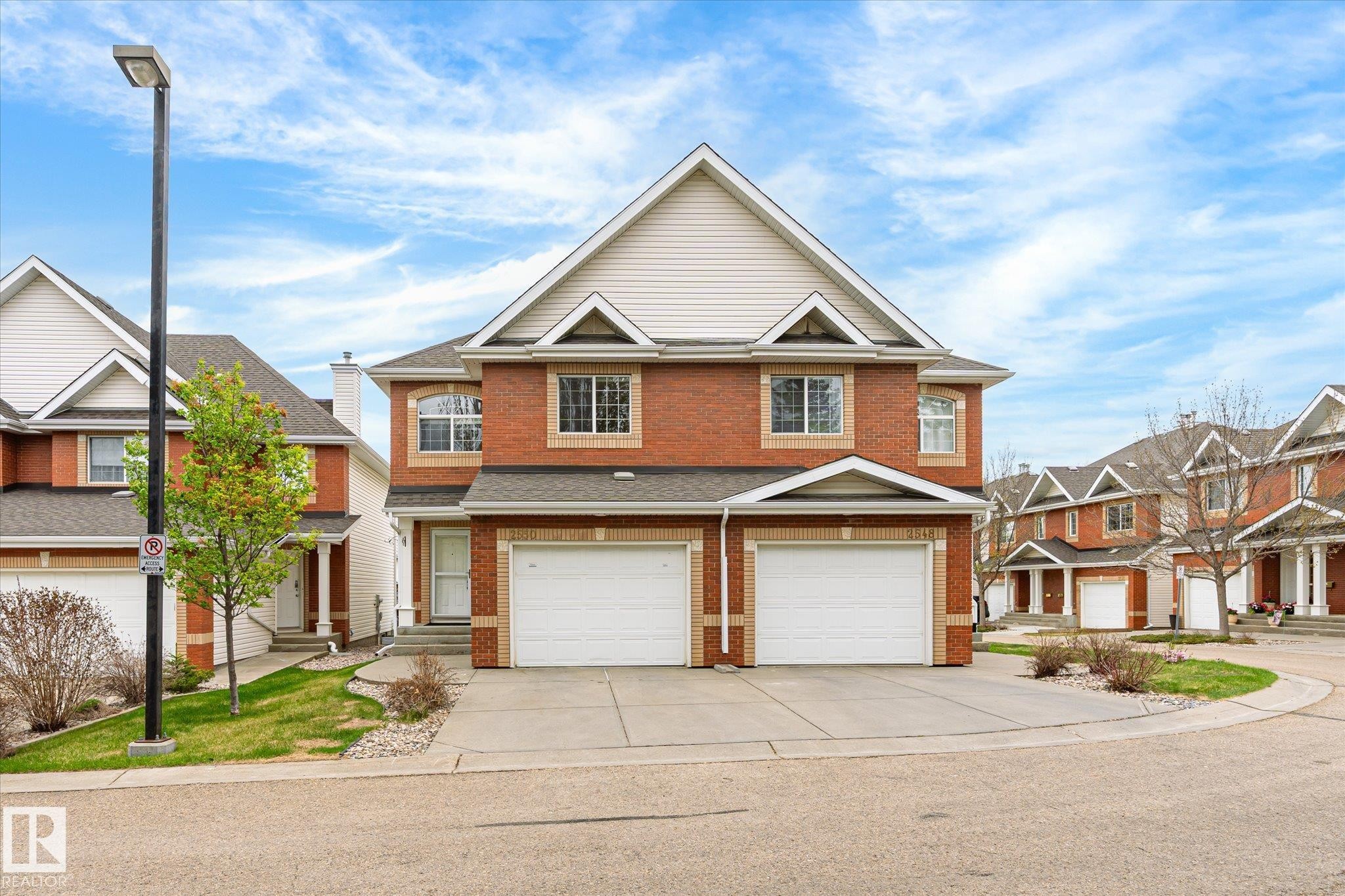 Brick exterior with white siding accents - 2550 Rabbit Hill Road Nw, Edmonton, AB