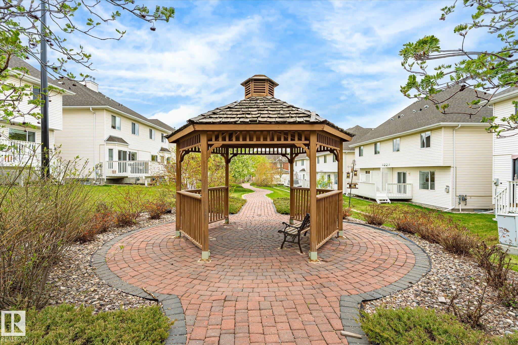 Central wooden gazebo with a shingled roof, set on a circular brick-paver patio - 2550 Rabbit Hill Road Nw, Edmonton, AB