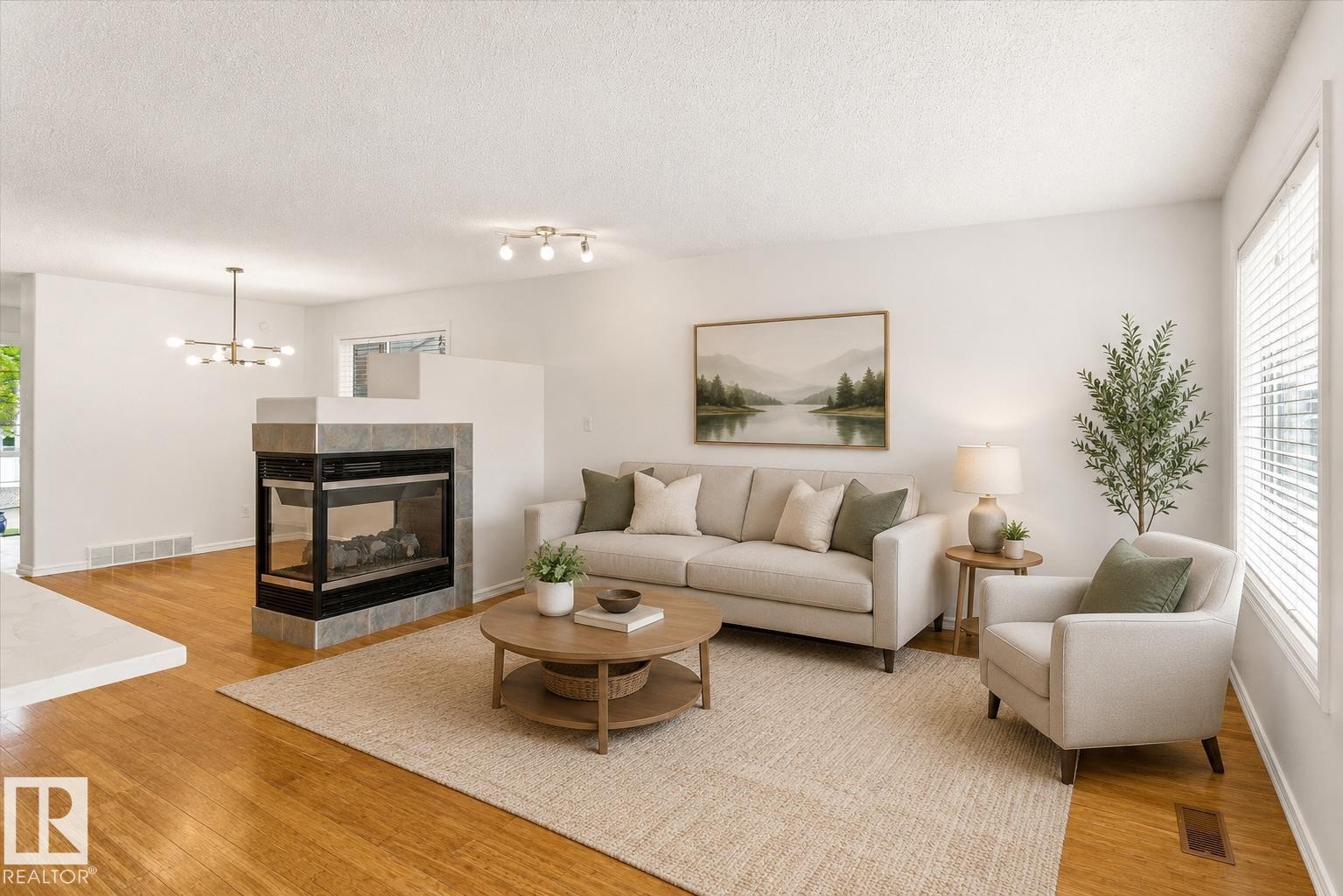Hardwood-finish flooring, a two-sided fireplace with a tile surround, and large windows with blinds - 2550 Rabbit Hill Road Nw, Edmonton, AB