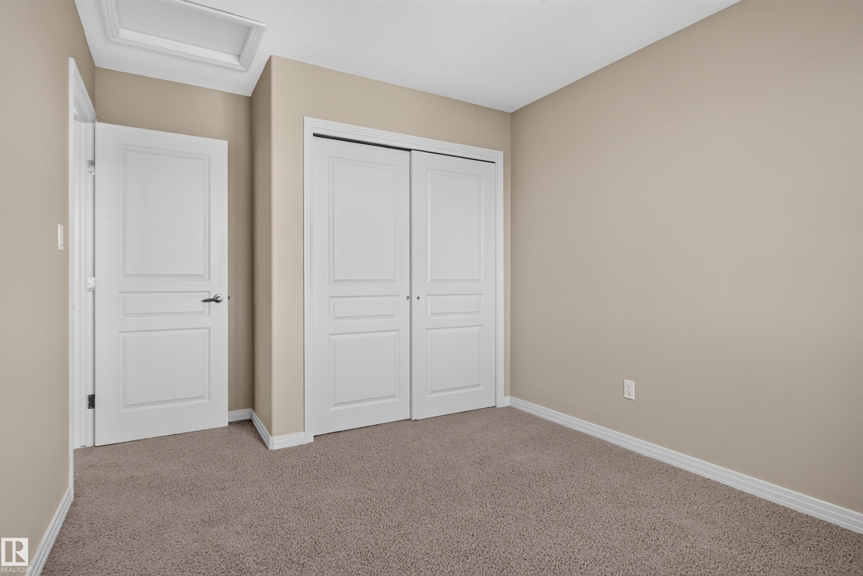 Neutral-toned wall paint, white trim, and carpeting - 2145 28 Street Nw, Edmonton, AB