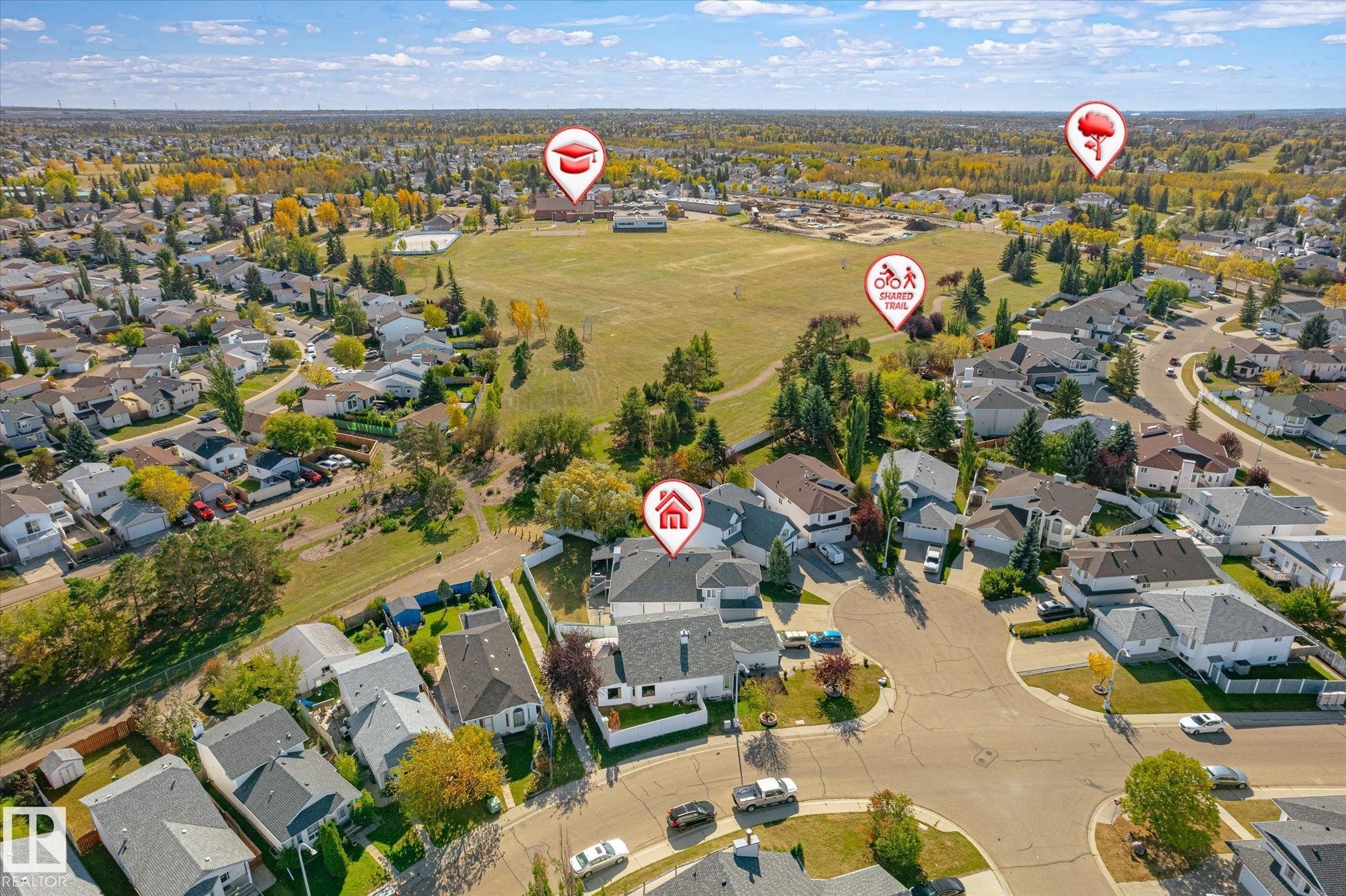 Residential neighborhood with a curved street layout, mature trees, and nearby open green spaces - 771 Johns Road Nw, Edmonton, AB