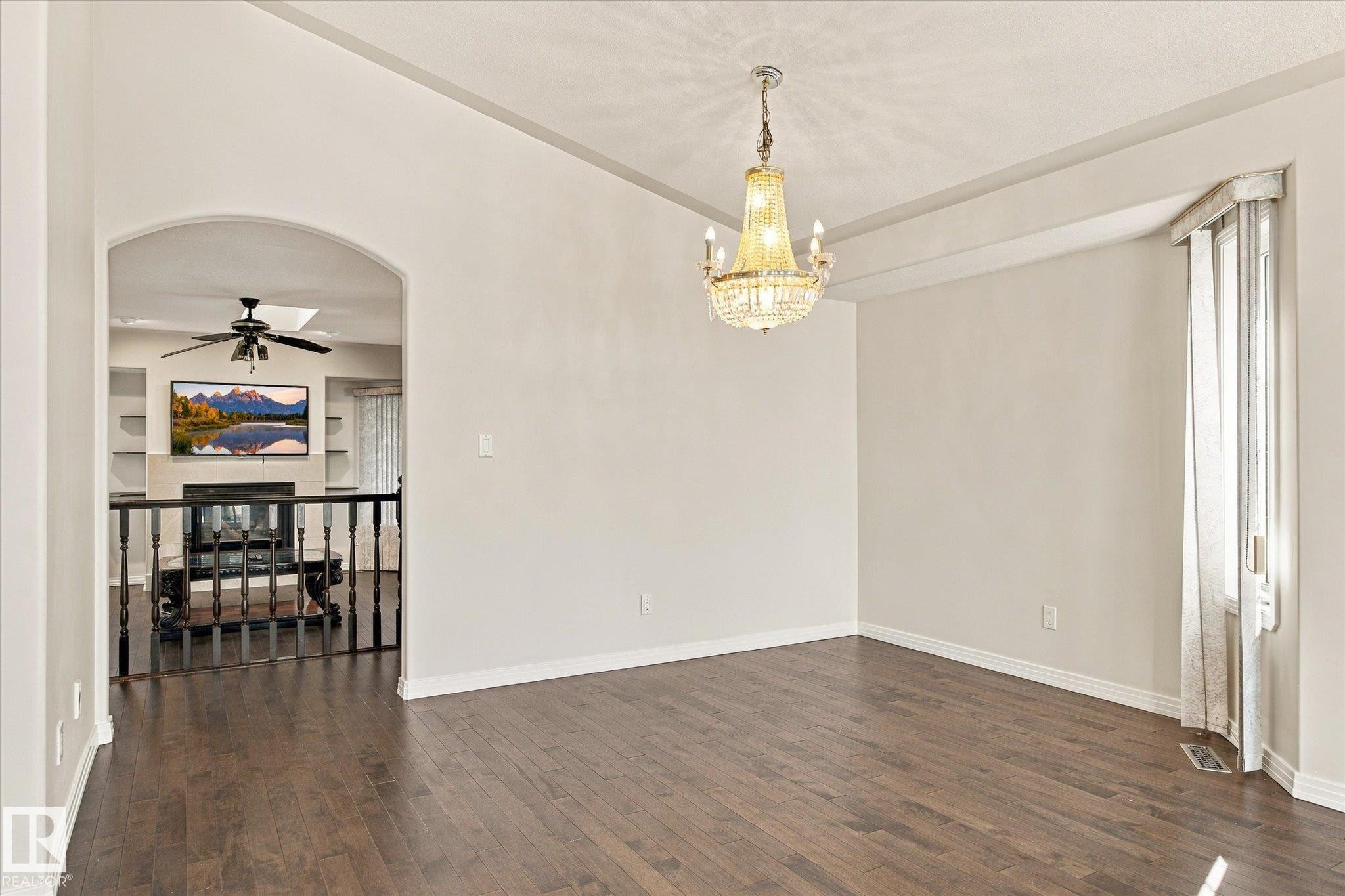 Dark wood-finish flooring with an arched entry - 771 Johns Road Nw, Edmonton, AB