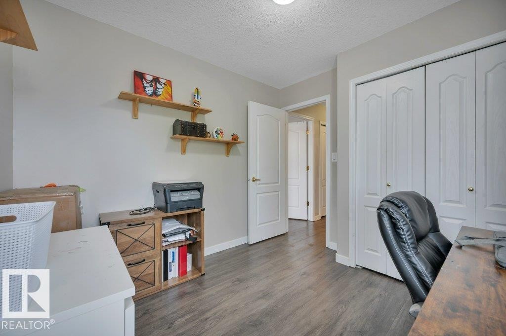 Vinyl plank flooring throughout, bright walls, and a convenient closet with bi-fold doors - 11448 169 Avenue Nw, Edmonton, AB