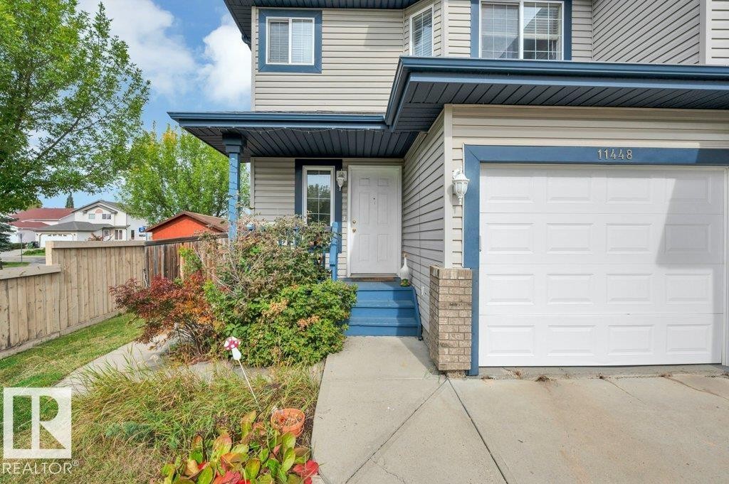 Light-colored siding exterior with blue trim accents - 11448 169 Avenue Nw, Edmonton, AB