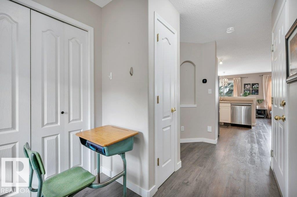 Vinyl plank flooring throughout, bright white trim, and a decorative wall niche - 11448 169 Avenue Nw, Edmonton, AB