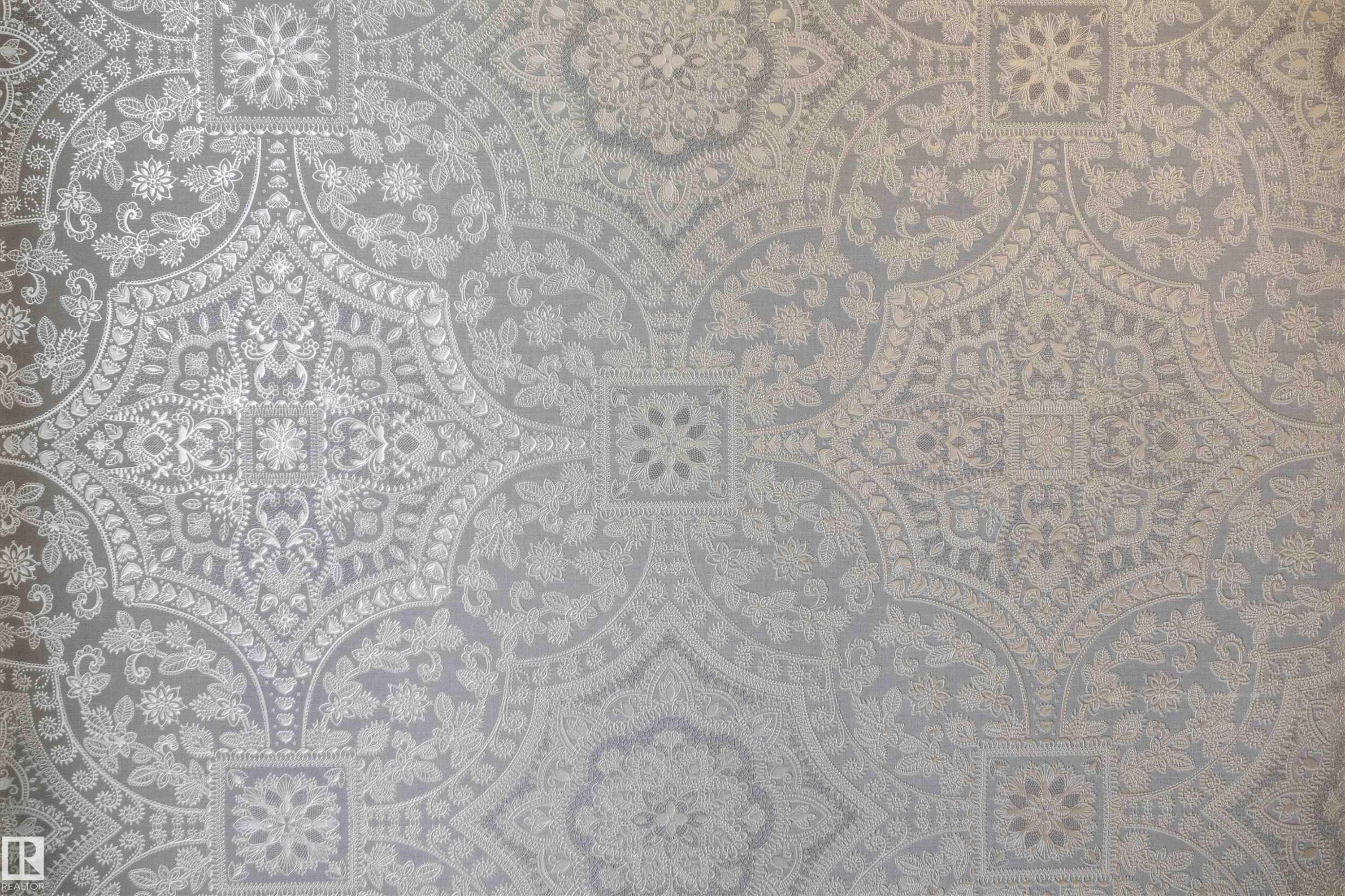 Intricate, embossed wall covering featuring a repeating monochromatic damask pattern - 2045 209A St Nw, Edmonton, AB