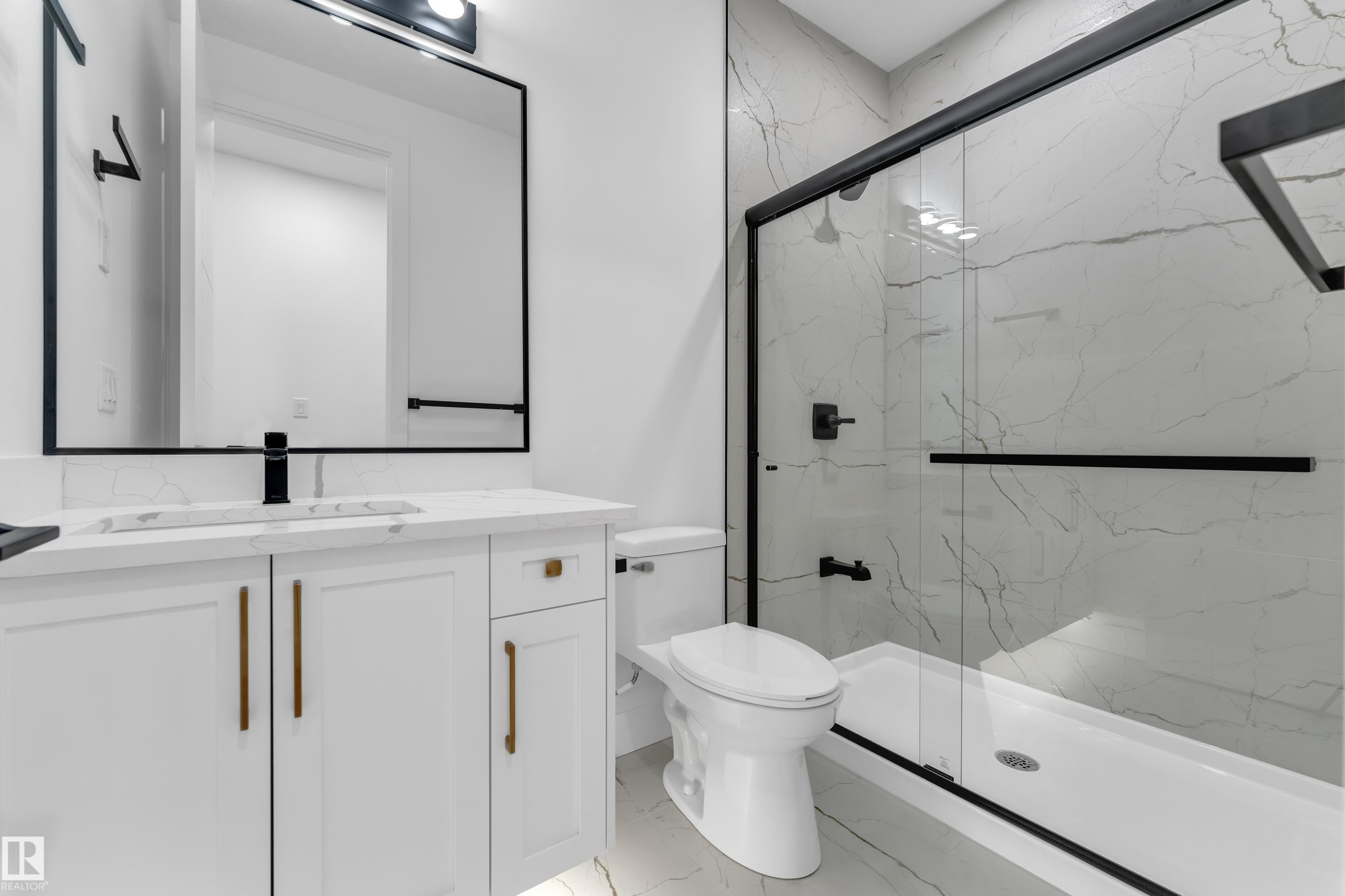 White vanity with gold-finish hardware, rectangular undermount sink, and black matte faucet - 3604 44 Avenue, Beaumont, AB