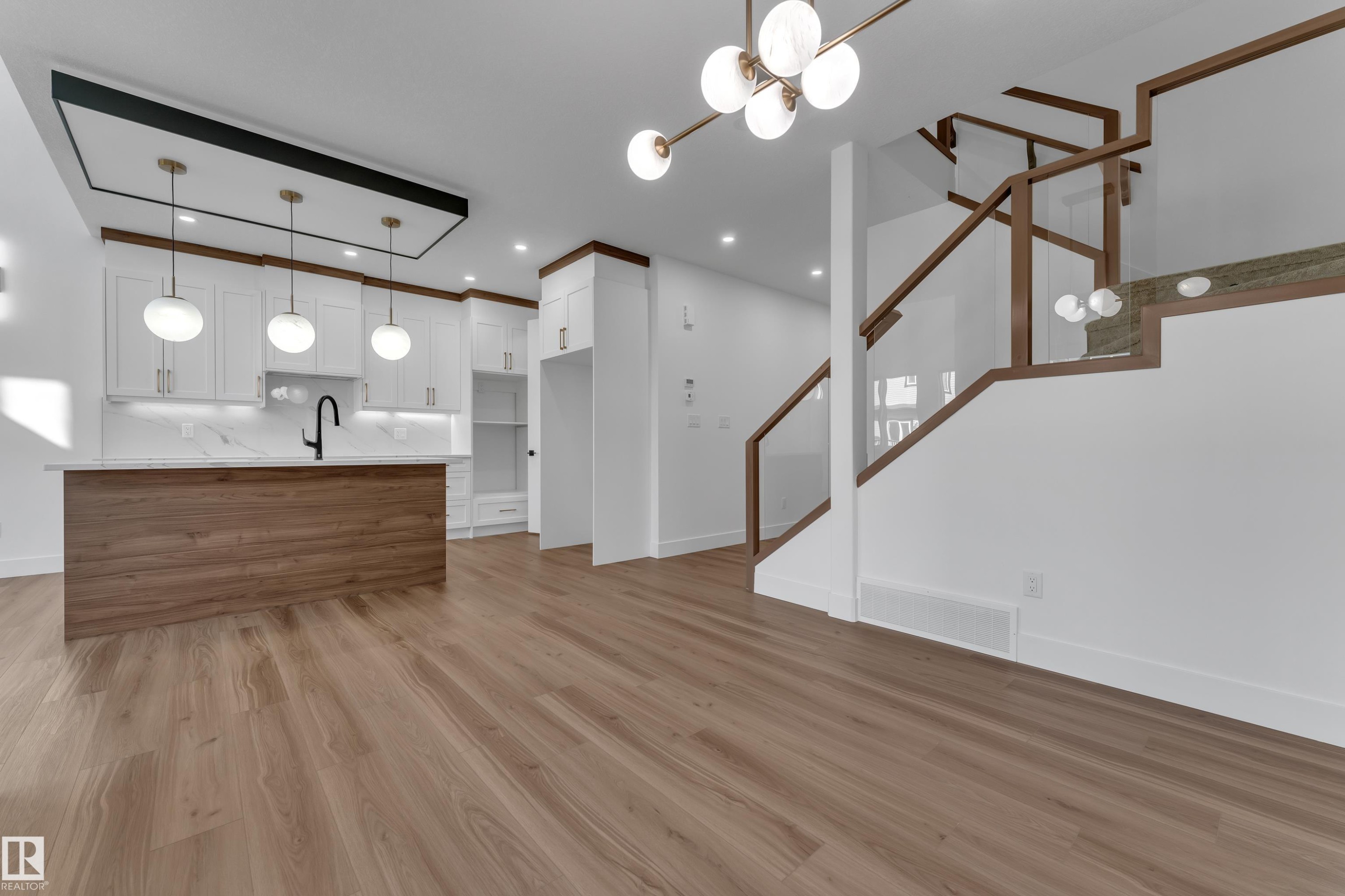 Open-concept space featuring wood-finish flooring - 3604 44 Avenue, Beaumont, AB