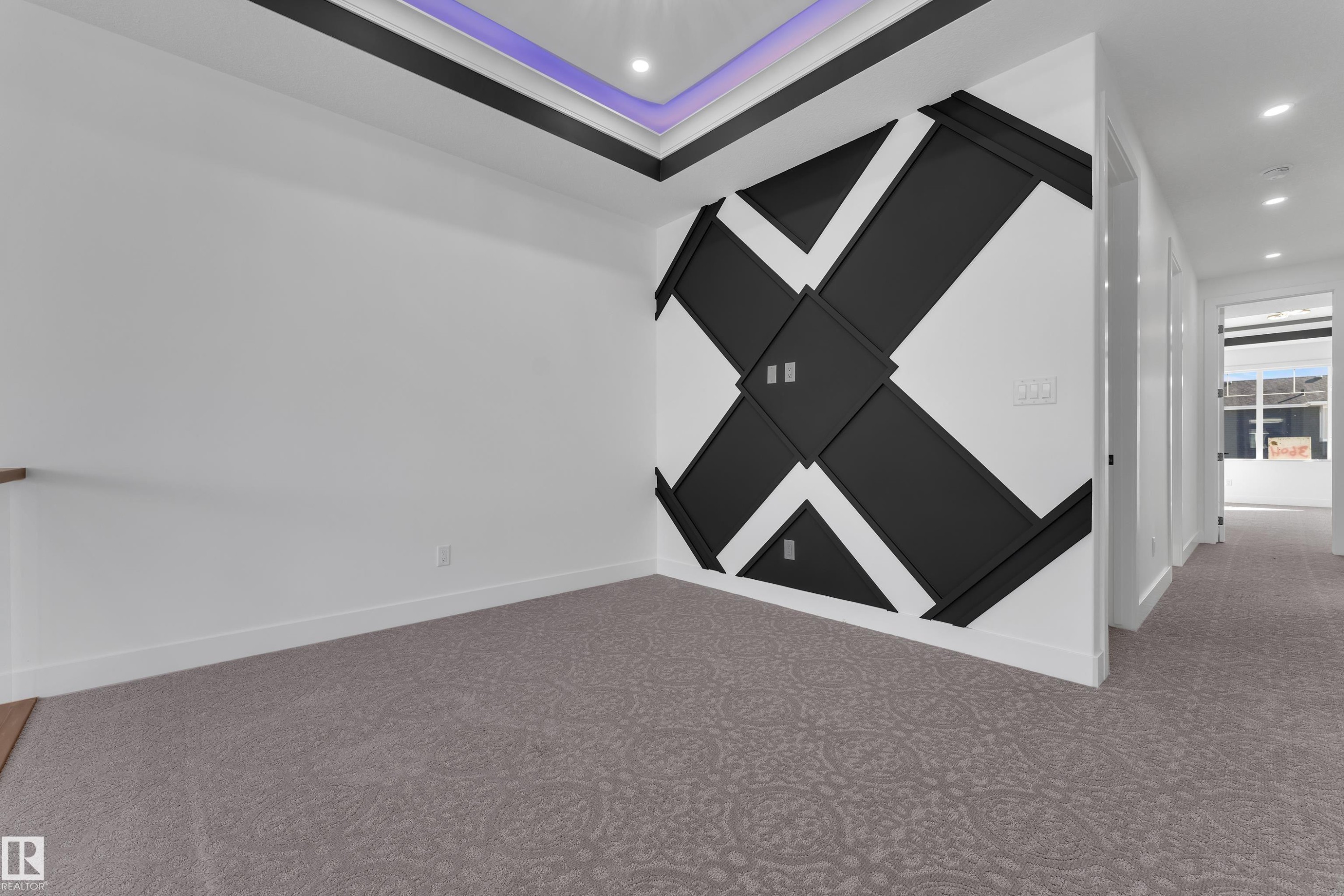 Recessed lighting, tray ceiling with accent lighting, decorative wall paneling, patterned carpeting, and wood-finish flooring - 3604 44 Avenue, Beaumont, AB