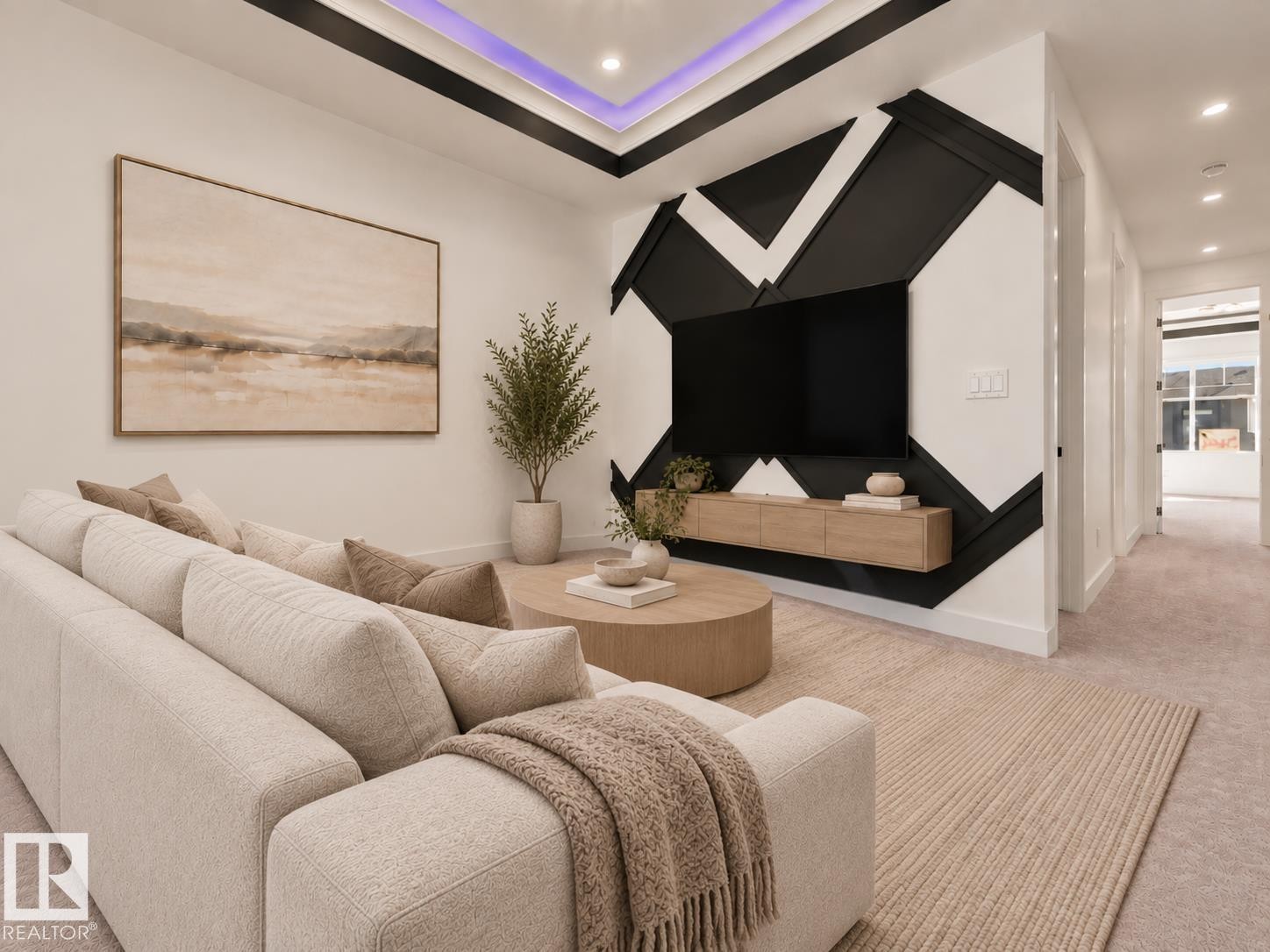 Recessed ceiling lighting, tray ceiling with accent lighting, accent wall with geometric design, wall-mounted media console, and carpet flooring - 3604 44 Avenue, Beaumont, AB