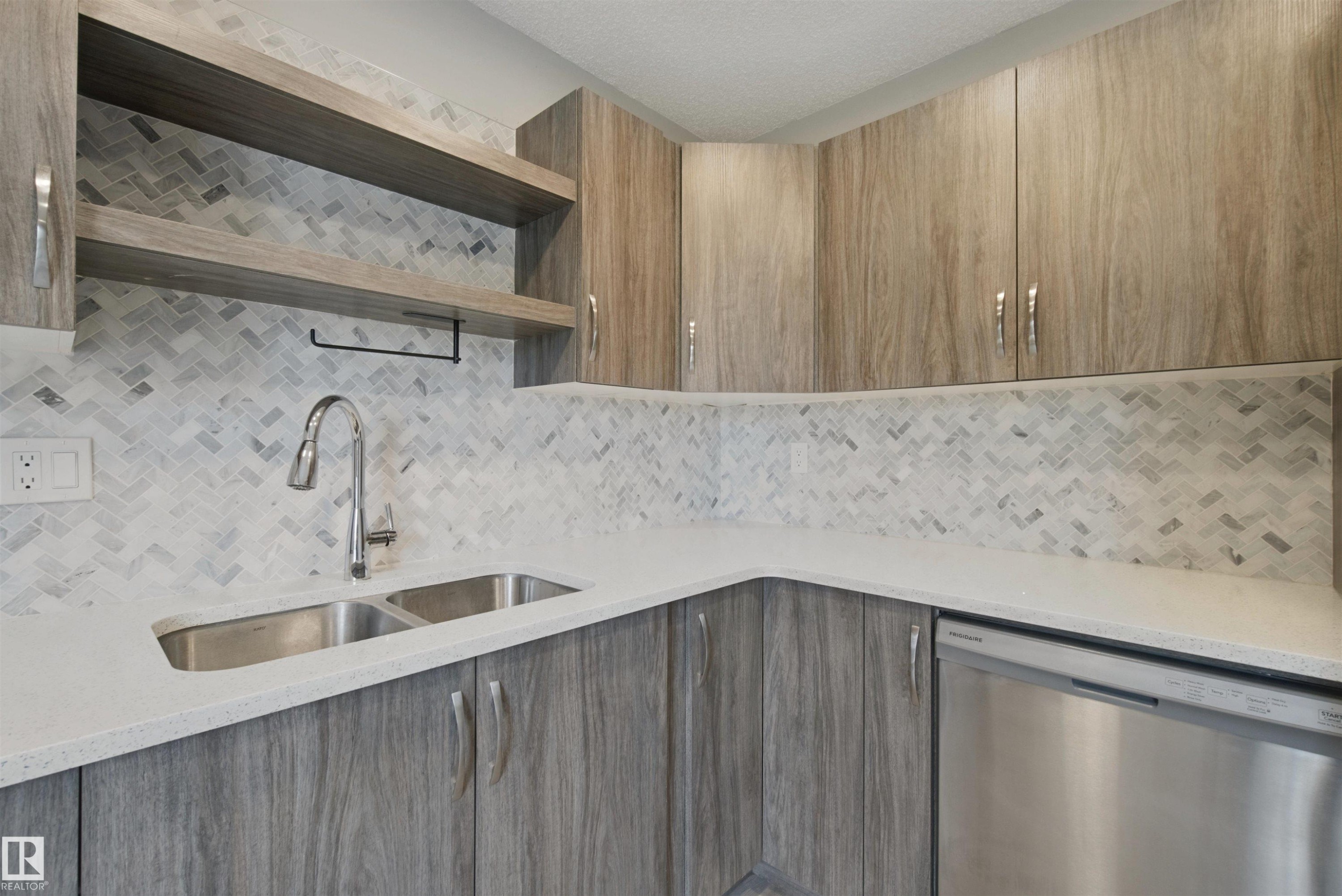Wood-finish cabinetry and open shelving complement the white countertop and herringbone tile backsplash - 13212 73 Street Nw, Edmonton, AB