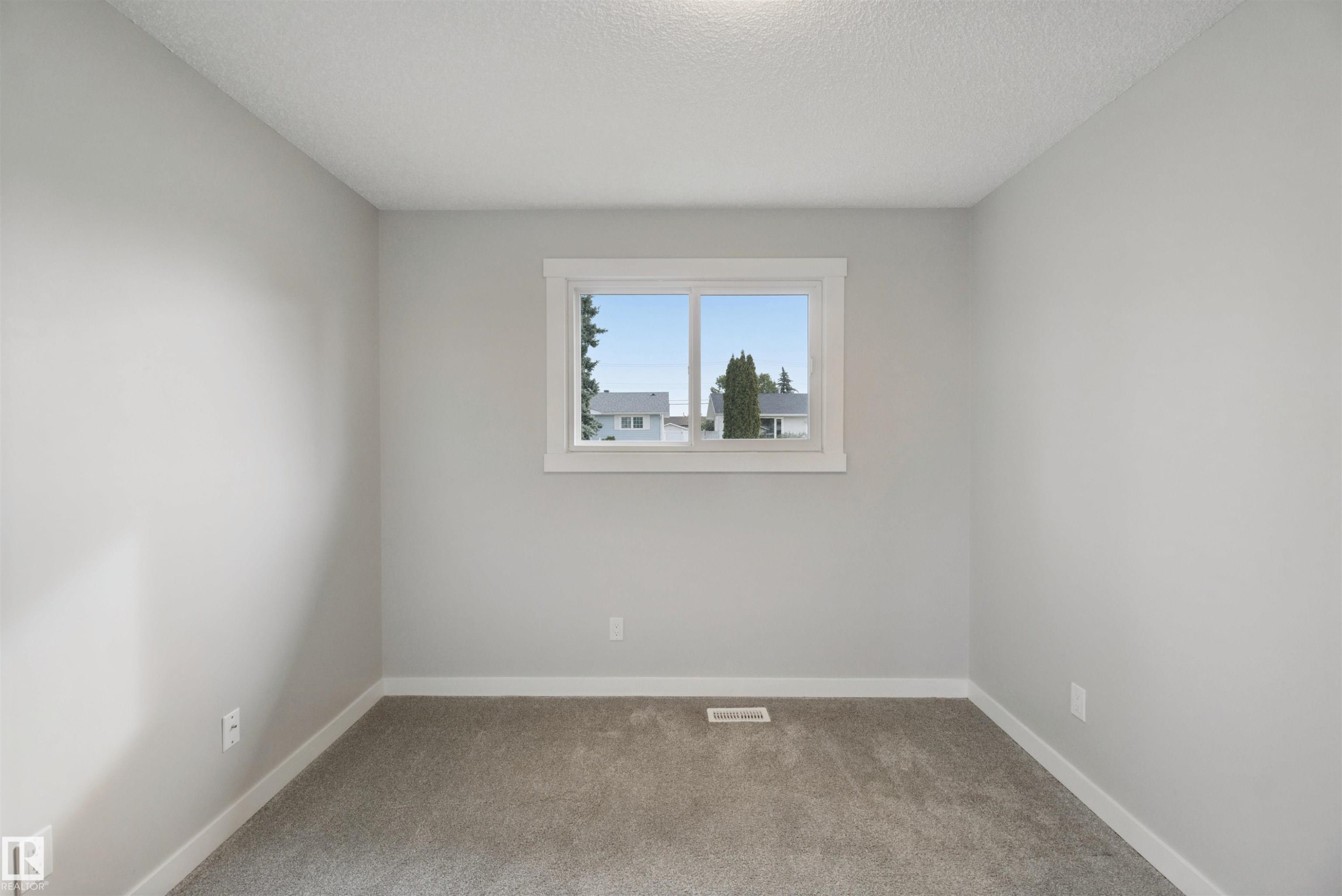 Neutral wall color, window with white trim, gray carpeting - 13212 73 Street Nw, Edmonton, AB