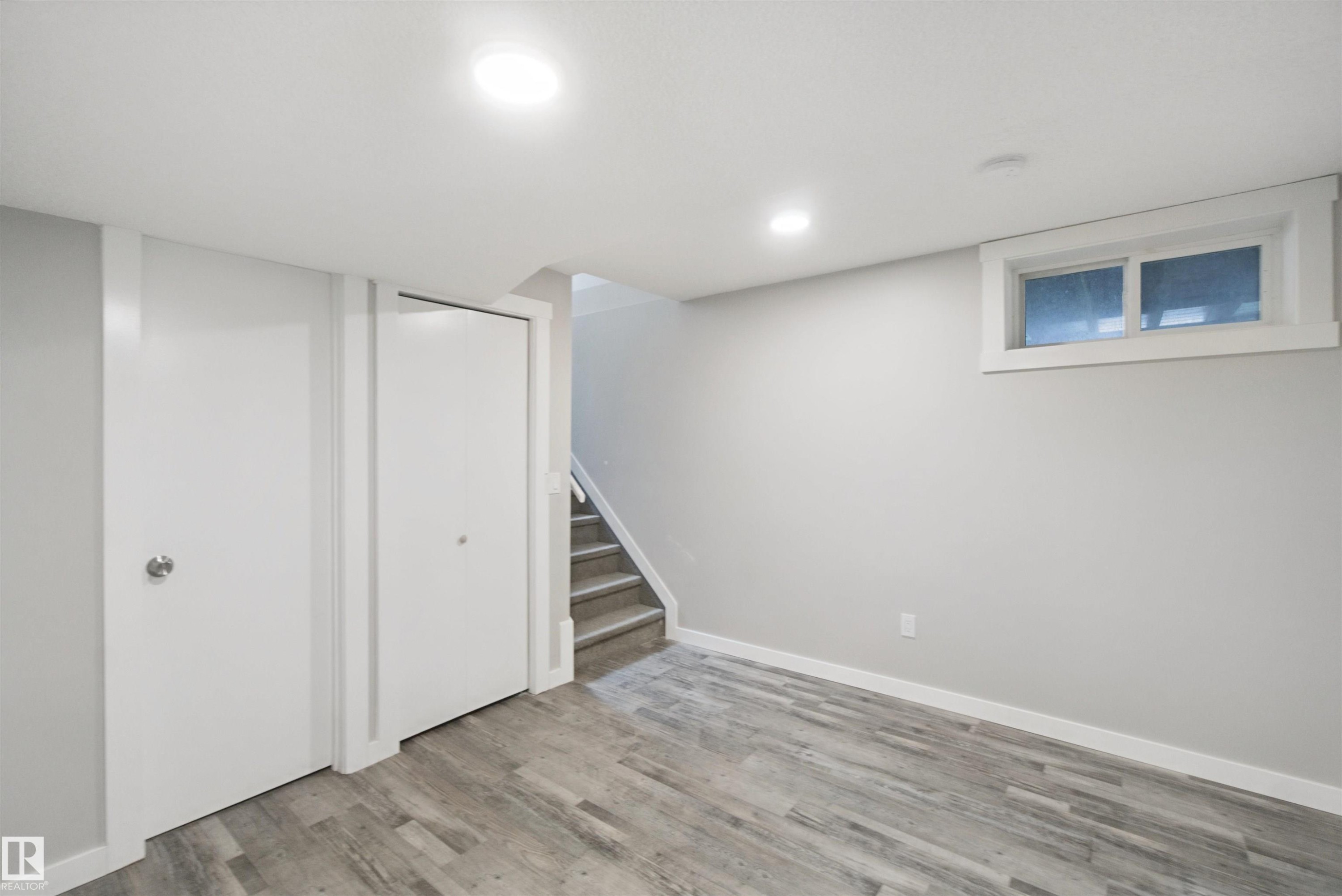 Recessed ceiling lighting, wood-finish flooring, white trim, white walls, and a window with white casing - 13212 73 Street Nw, Edmonton, AB