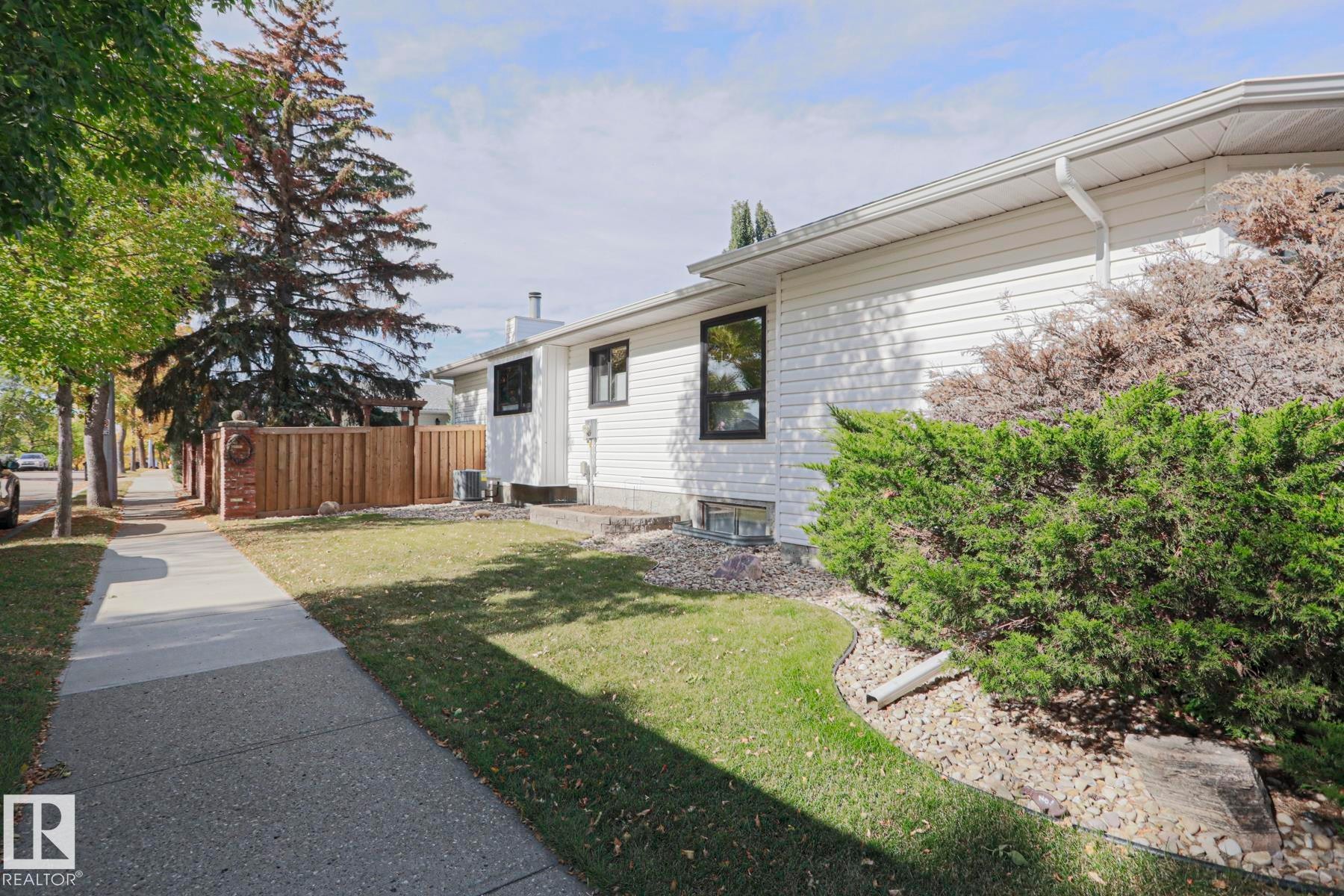 White siding exterior with black-framed windows - 2 Hillview Crescent, Sherwood Park, AB