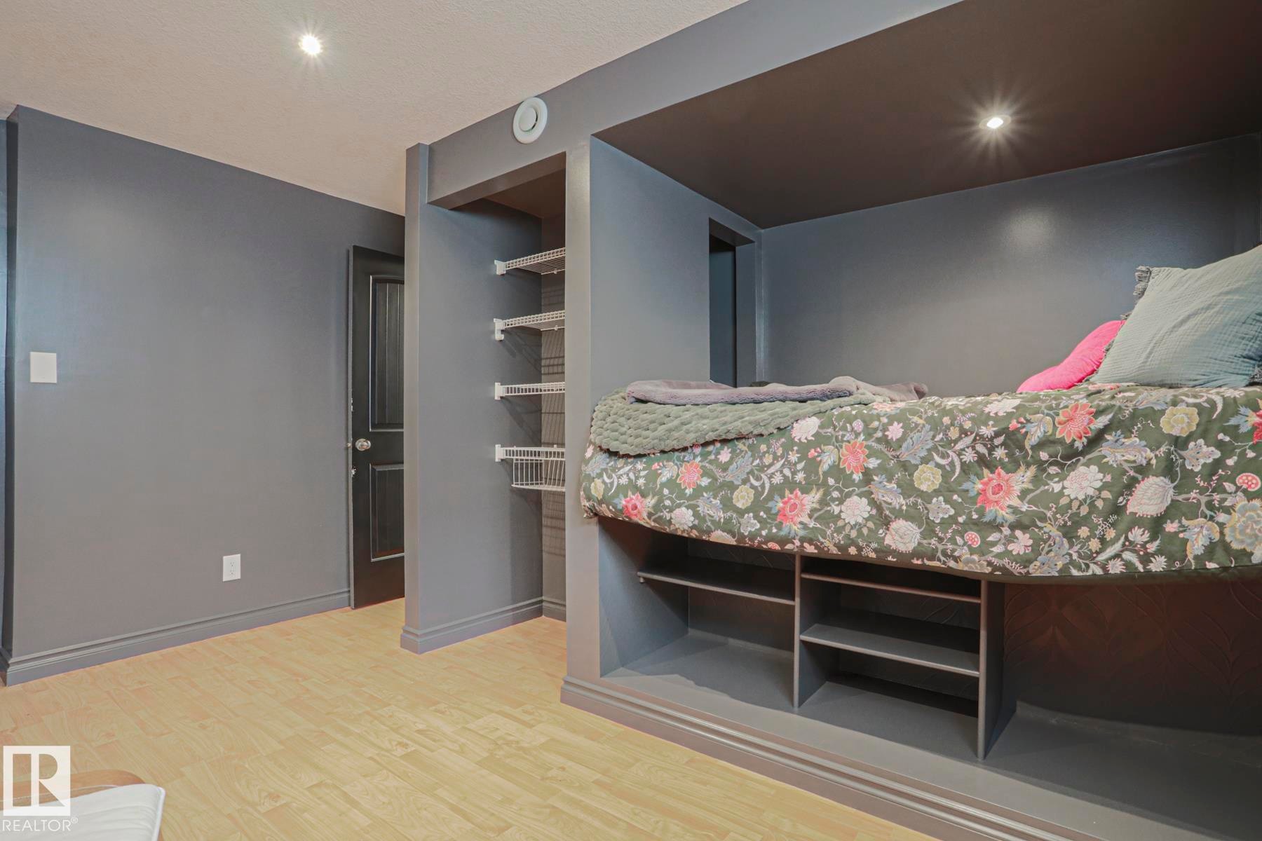 Recessed lighting, wood-finish flooring, built-in shelving, and a built-in bed frame with integrated storage - 2 Hillview Crescent, Sherwood Park, AB