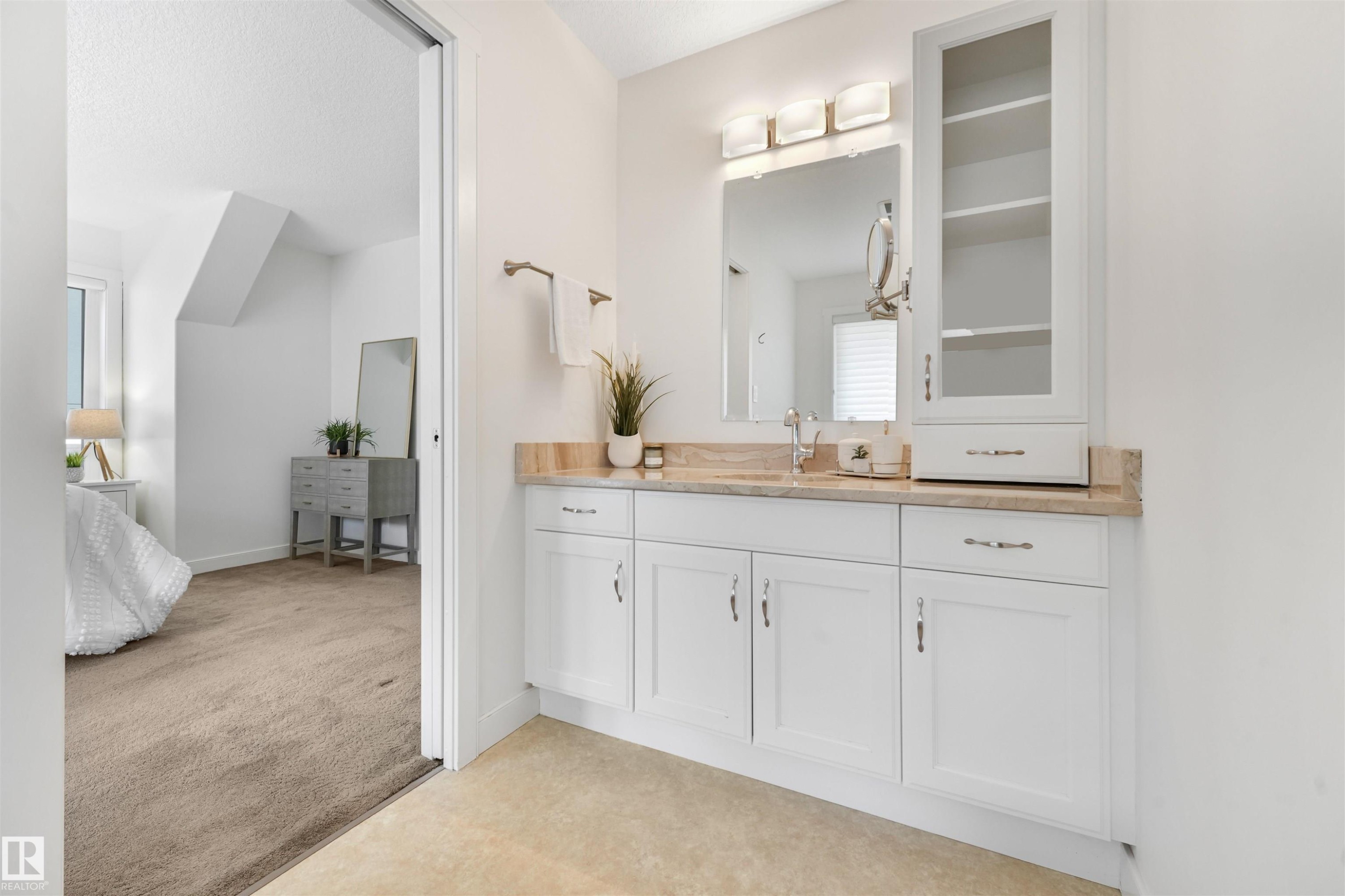 Vanity with white cabinetry, a single basin, and a light-colored countertop - 8212 148 Street Nw, Edmonton, AB