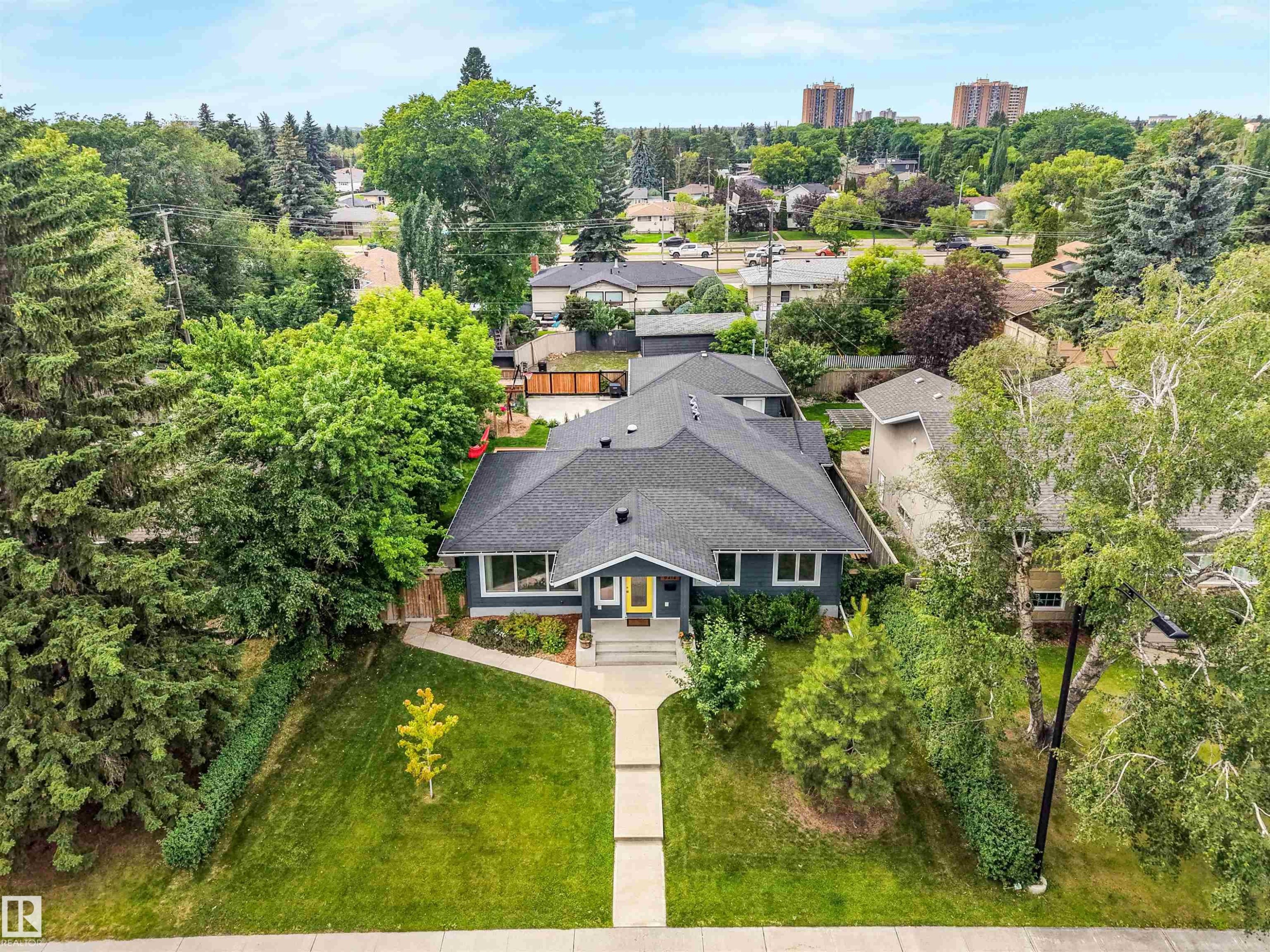Dark grey exterior with a contrasting yellow front door - 8212 148 Street Nw, Edmonton, AB