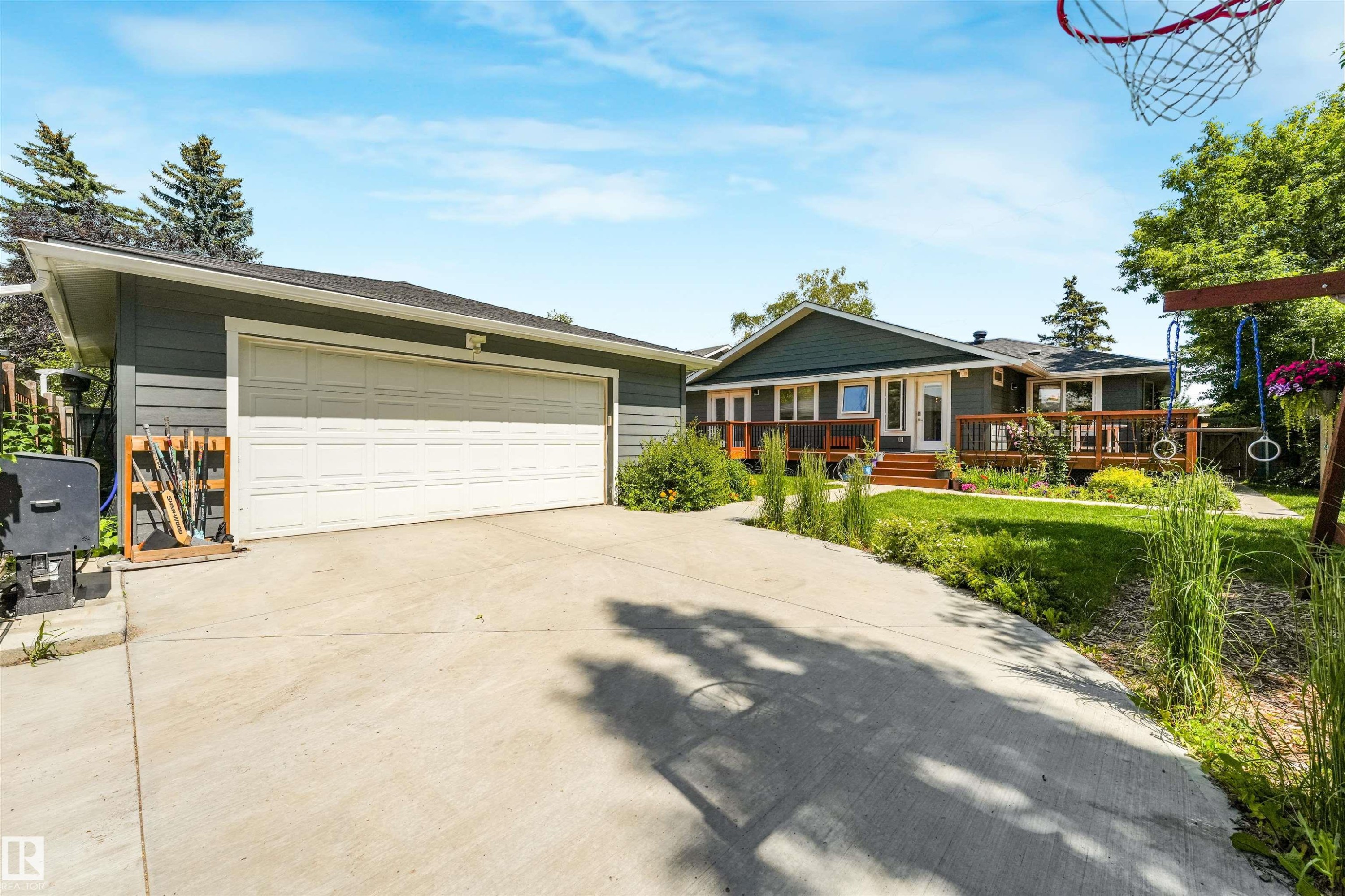 Attached garage with a white sectional door and concrete driveway - 8212 148 Street Nw, Edmonton, AB