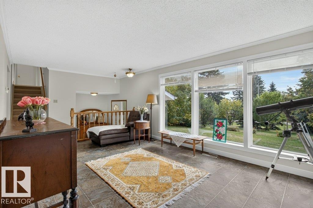 Floor-to-ceiling windows, wood staircase with railing, recessed lighting, ceiling fan, and tiled flooring - #74 22555 Twp Road 530, Rural Strathcona County, AB