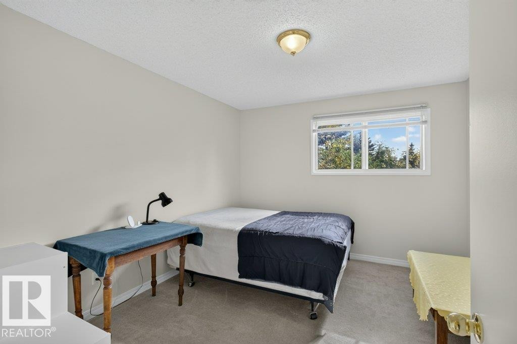 Carpeted flooring, neutral wall color, window with white blinds, and a ceiling-mounted light fixture - #74 22555 Twp Road 530, Rural Strathcona County, AB