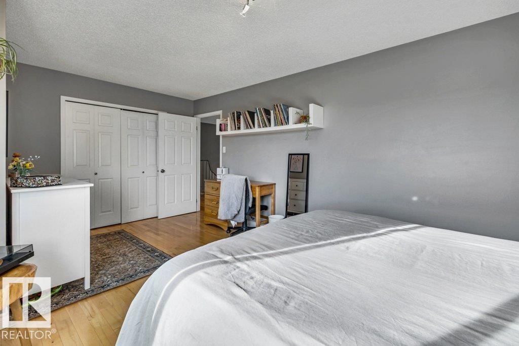 Hardwood-finish flooring, built-in shelving, and bi-fold closet doors - #24 3811 85 St Nw, Edmonton, AB