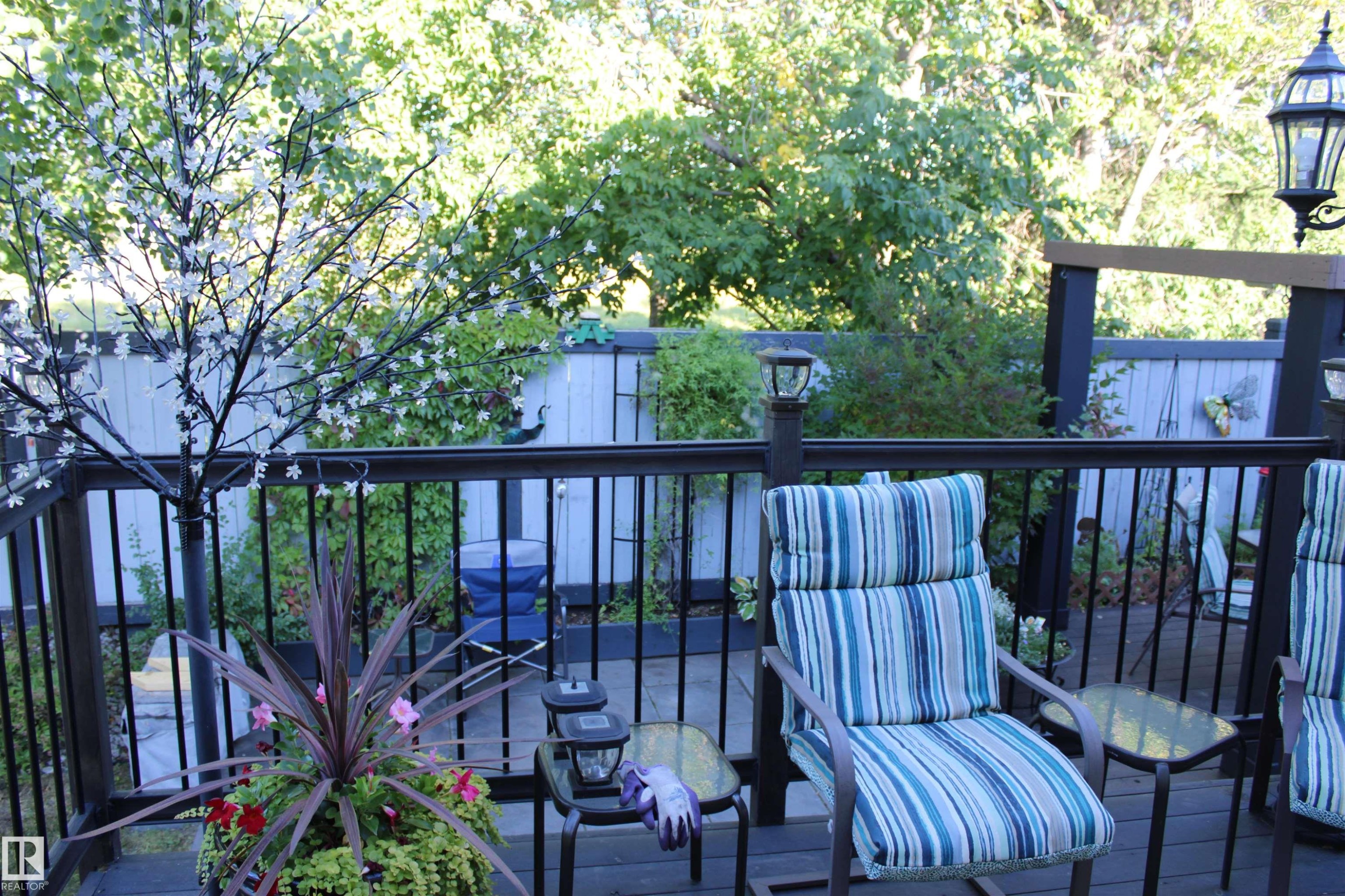 Expansive wooden deck with dark railing and integrated post lighting, offering an outdoor living area - 3815 41 Street Nw, Edmonton, AB