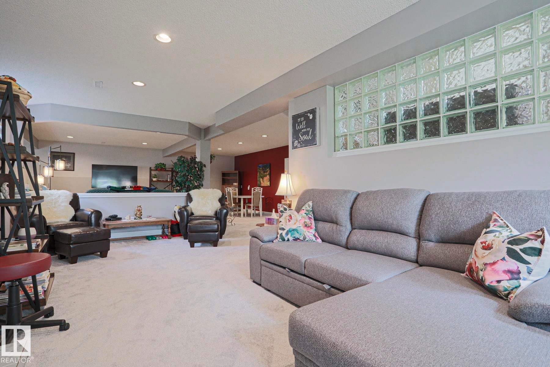 Recessed lighting throughout, glass block window, open concept layout, light-toned carpeting, and a built-in partial wall - 3815 41 Street Nw, Edmonton, AB