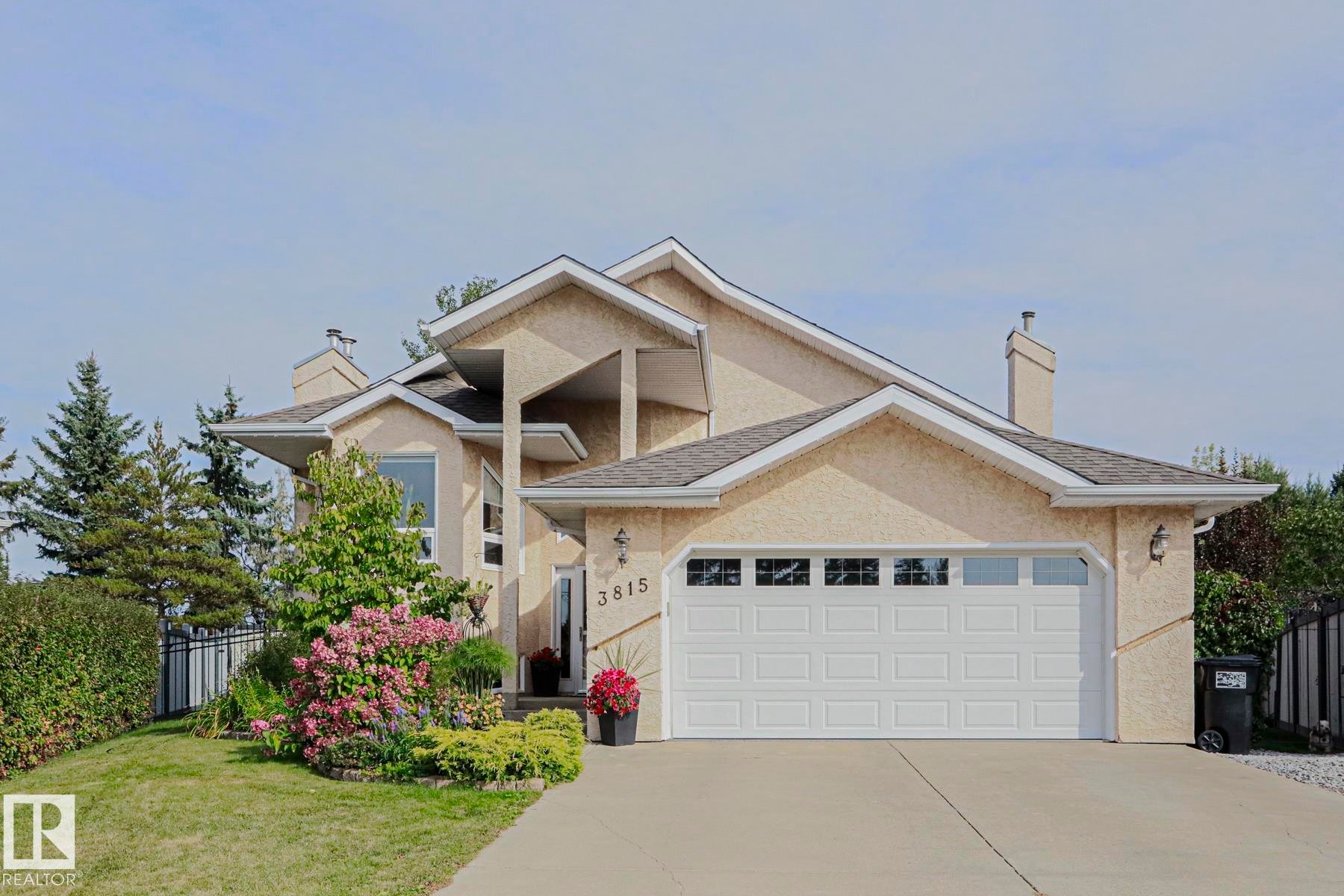 Stucco exterior with multiple gables and a multi-level roofline - 3815 41 Street Nw, Edmonton, AB
