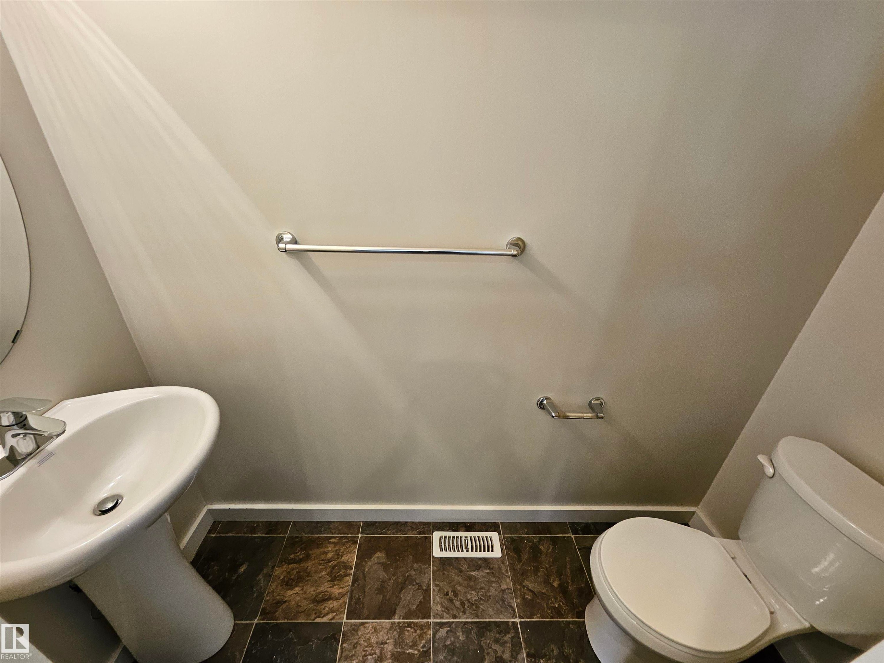 Pedestal sink with chrome faucet, tiled flooring, and a white toilet - #69 903 Crystallina Nera Wy Nw, Edmonton, AB