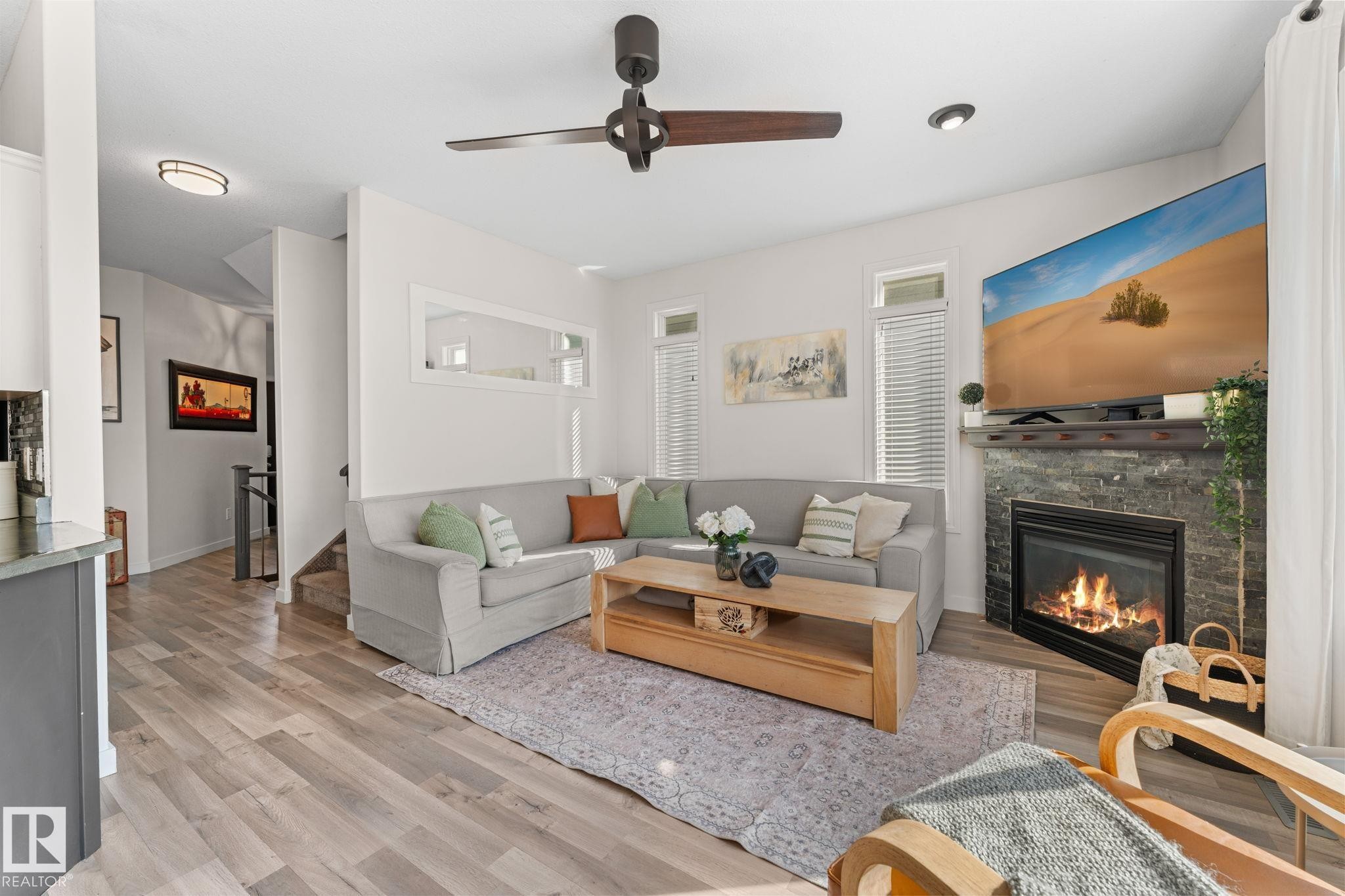Living area featuring wood-finish flooring, a contemporary ceiling fan, and recessed lighting - #5 4900 62 St, Beaumont, AB