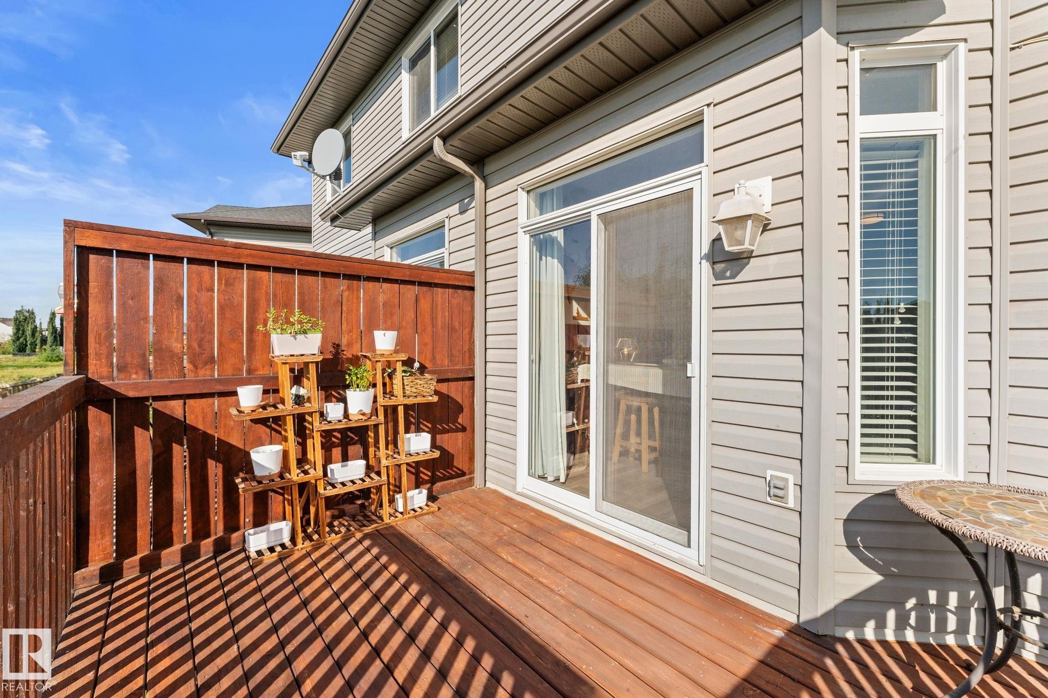 Private outdoor deck featuring wood flooring and a privacy fence - #5 4900 62 St, Beaumont, AB