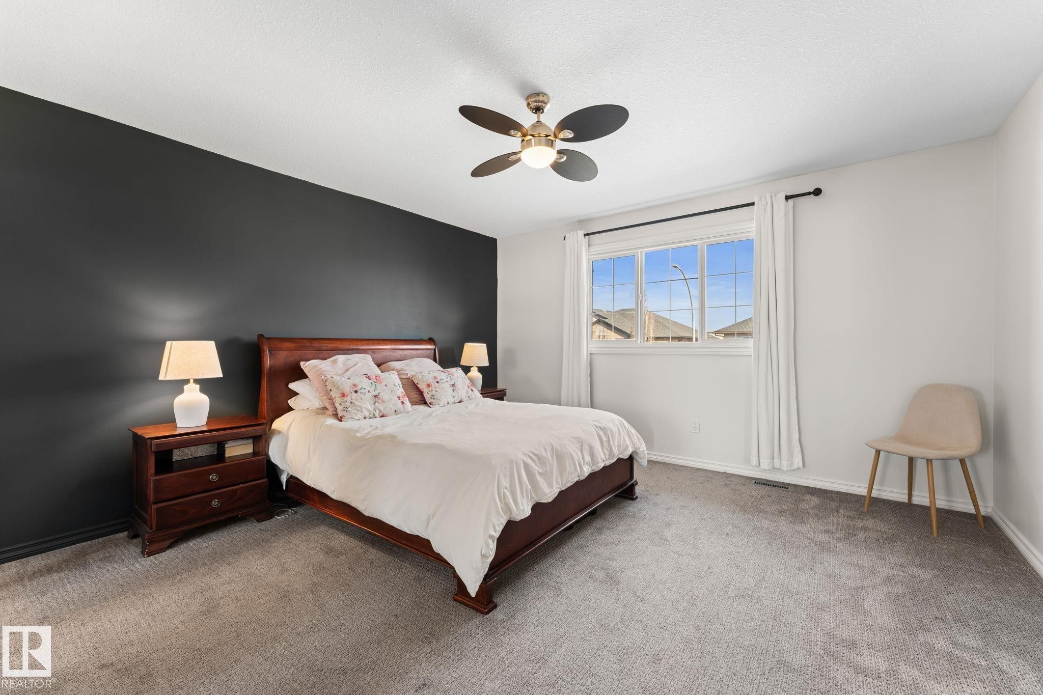 Recessed lighting, ceiling fan, carpeting, and a window with trim - #5 4900 62 St, Beaumont, AB
