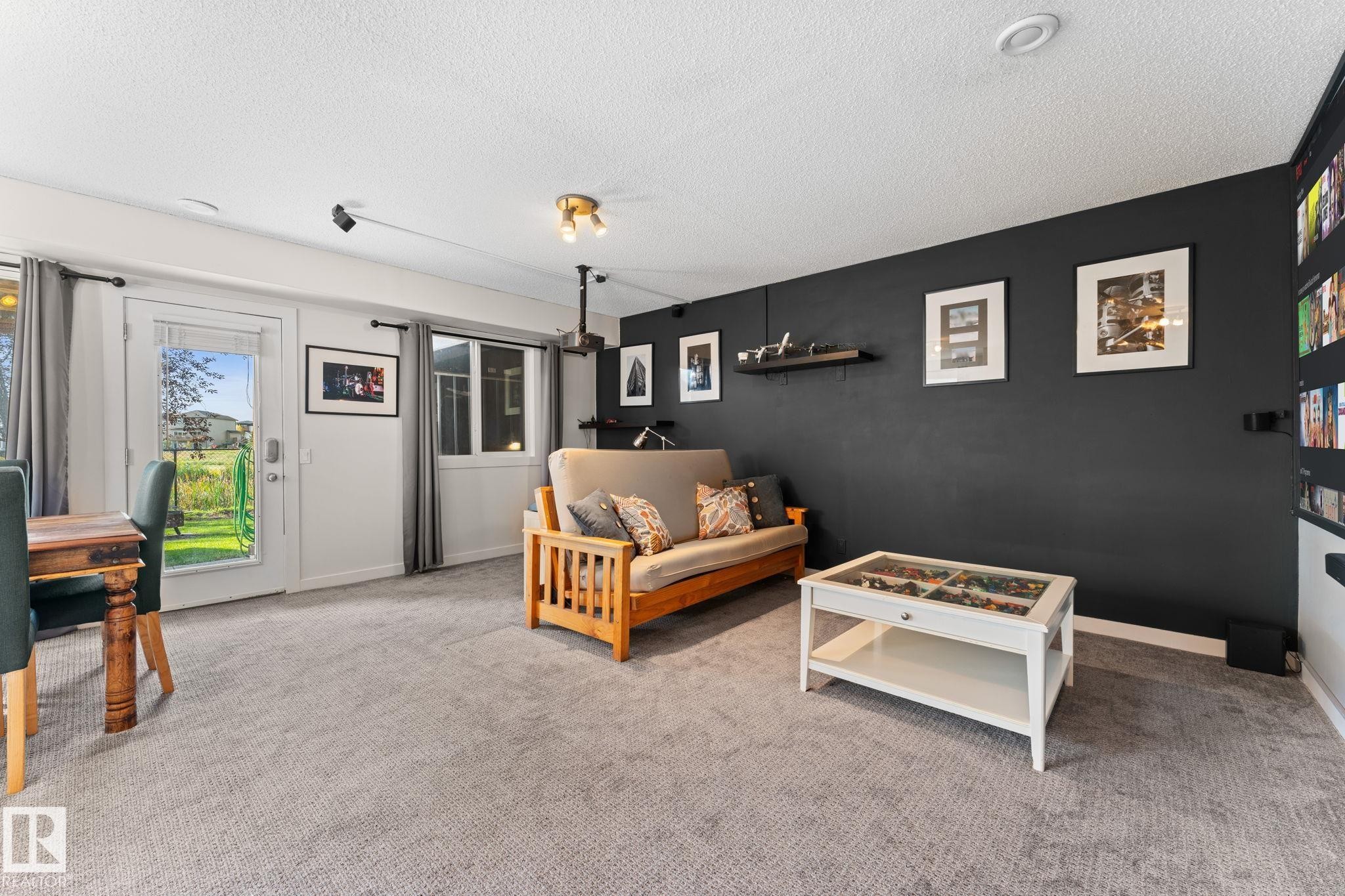 Recessed ceiling lighting, track lighting, and a prominent dark accent wall - #5 4900 62 St, Beaumont, AB