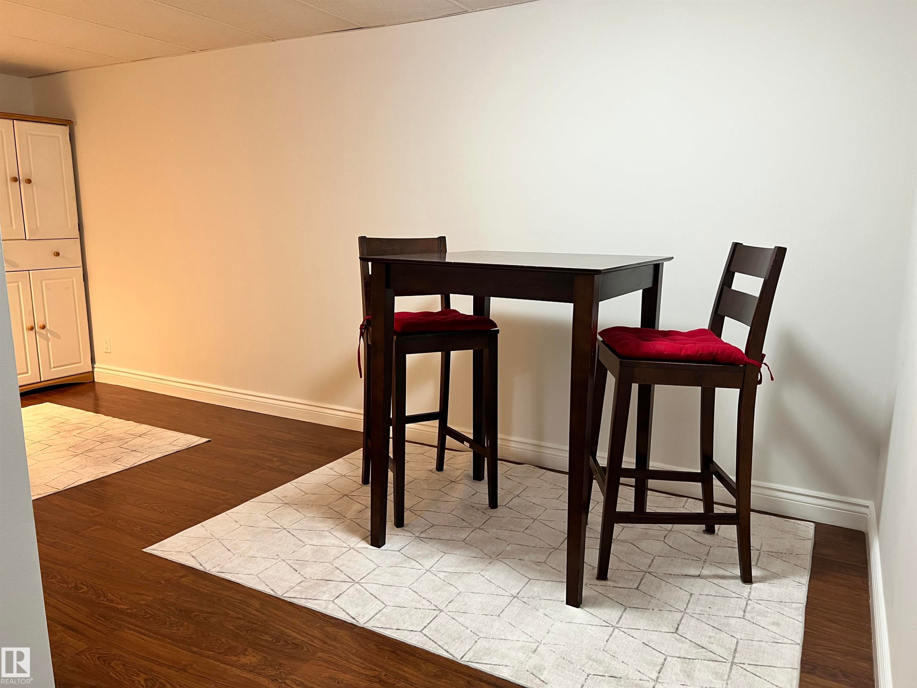 Wood-finish flooring with white wall finishes - 11908 131 Street Nw, Edmonton, AB