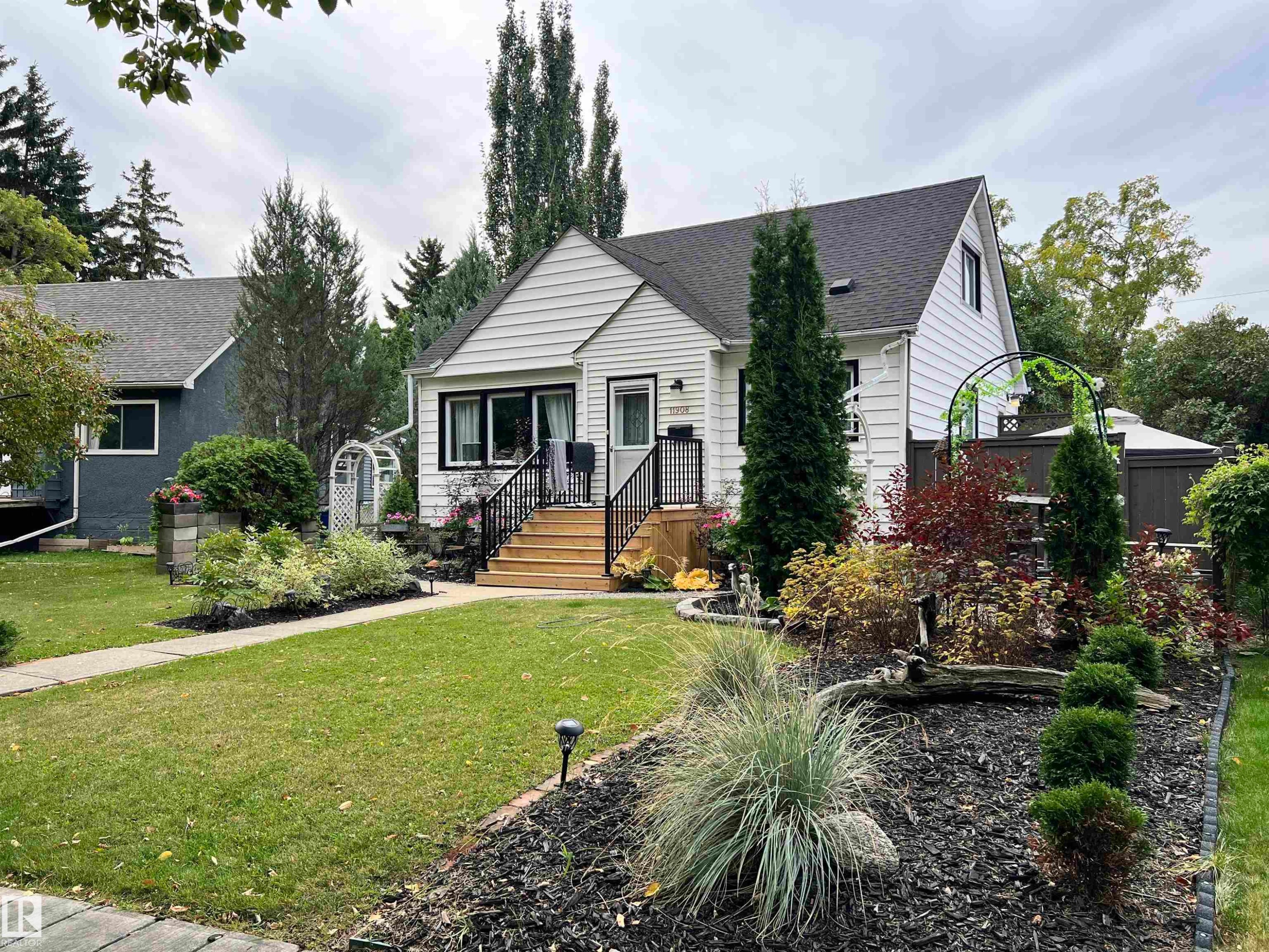White siding exterior with black trim windows - 11908 131 Street Nw, Edmonton, AB