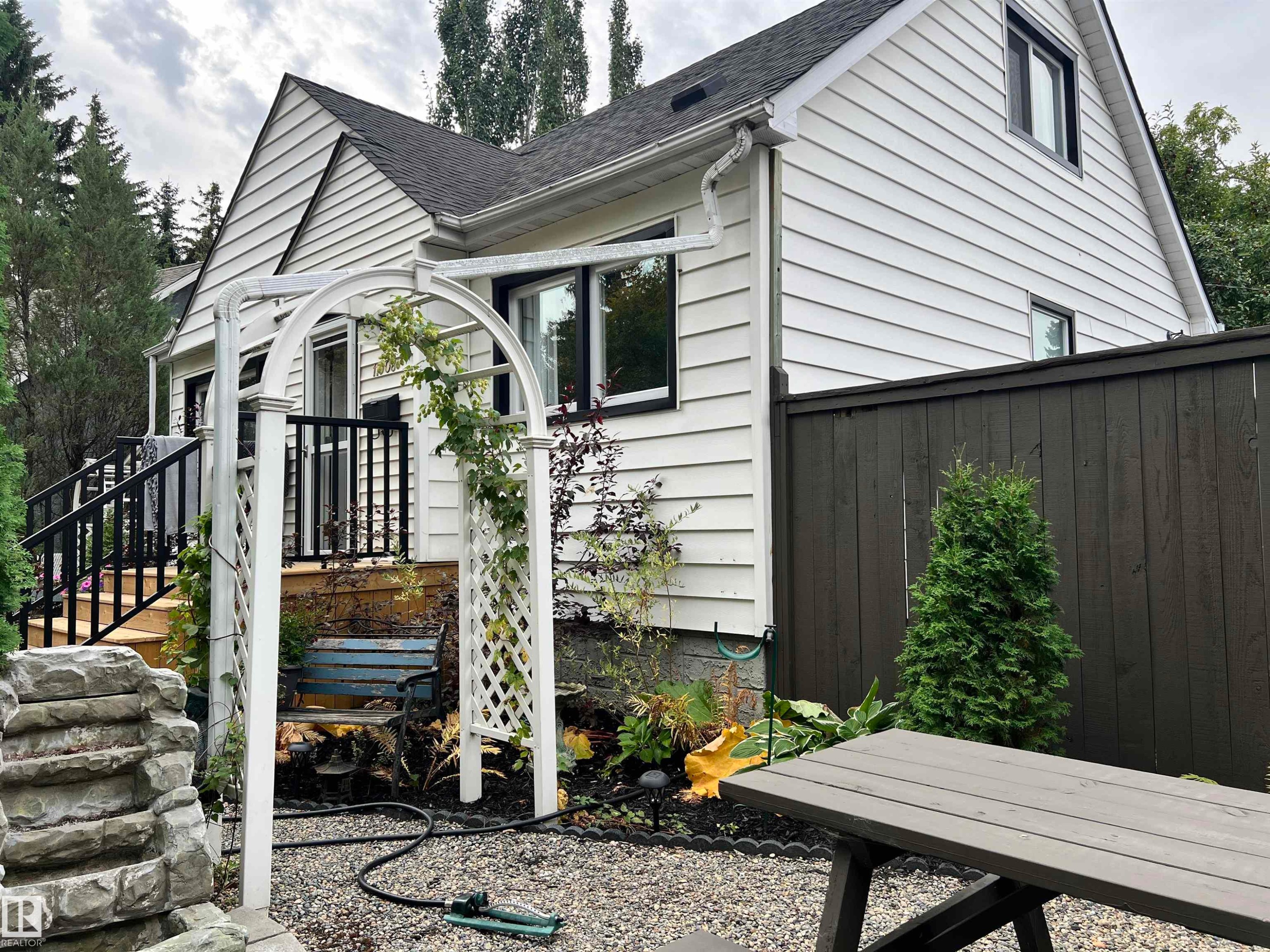 White horizontal siding exterior with black trim windows - 11908 131 Street Nw, Edmonton, AB