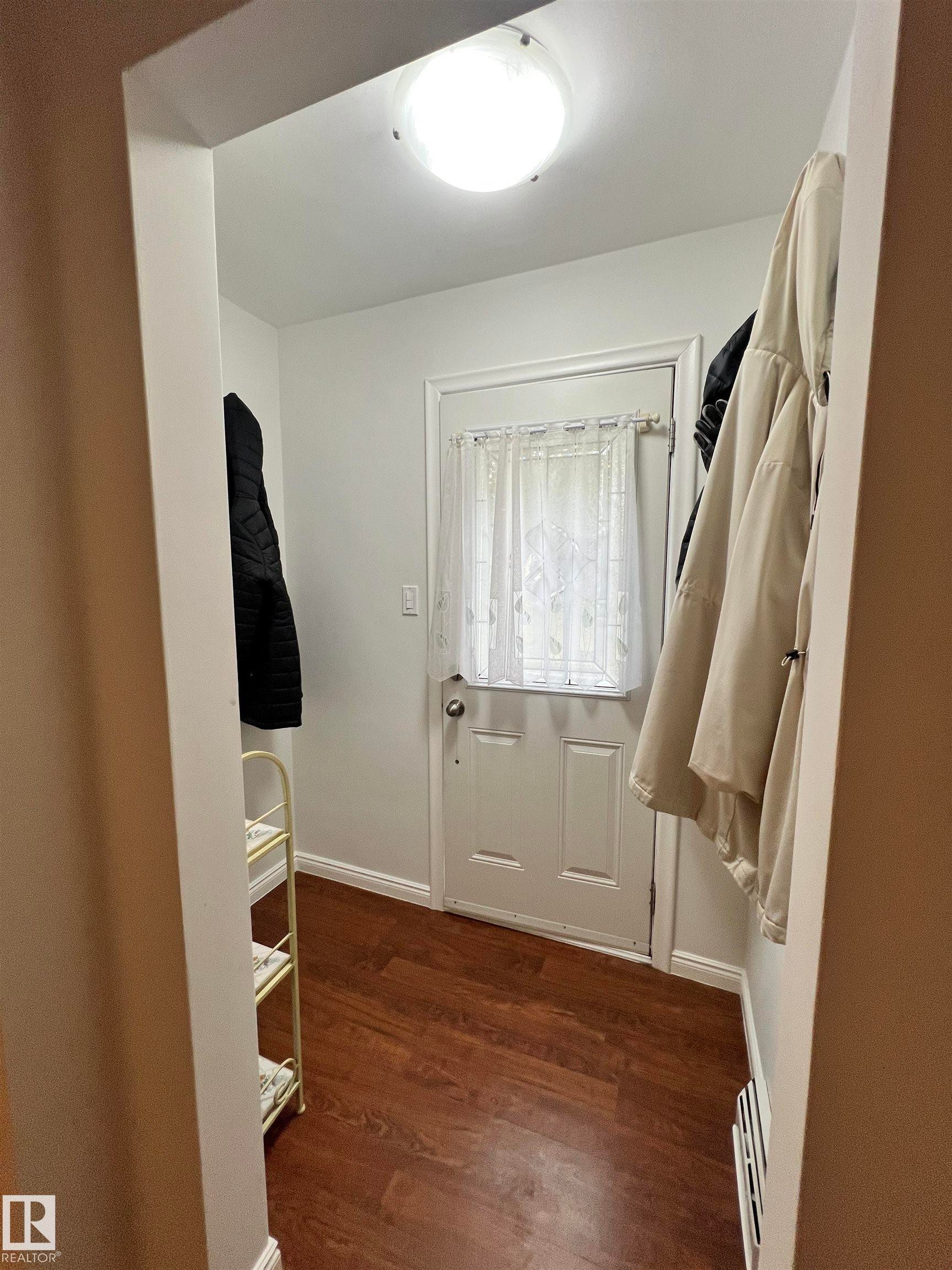 Entryway featuring wood-finish flooring, white walls, and a flush-mount ceiling light - 11908 131 Street Nw, Edmonton, AB