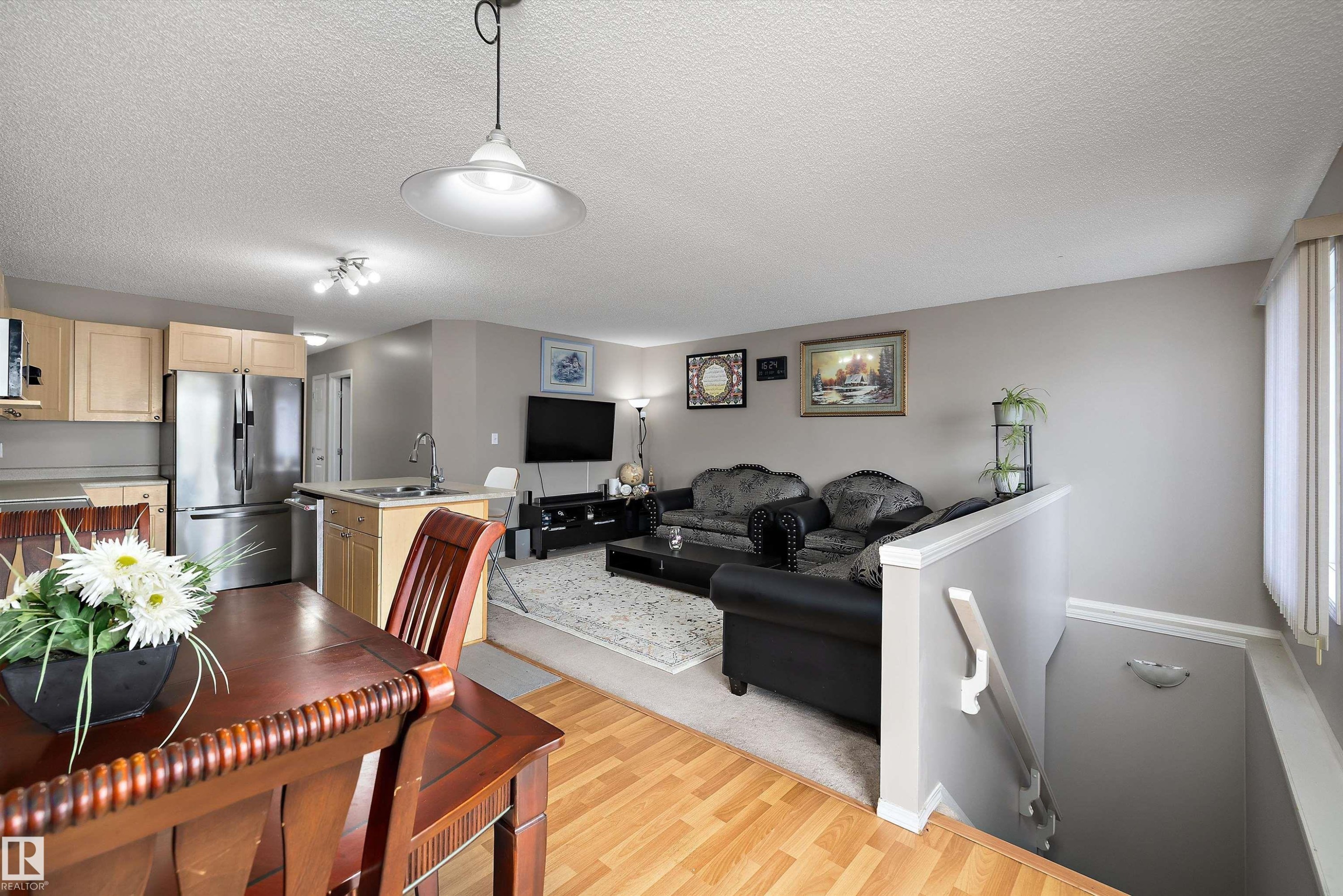 Kitchen with wood-finish cabinetry and stainless steel appliances - 3114 32 Avenue Nw, Edmonton, AB