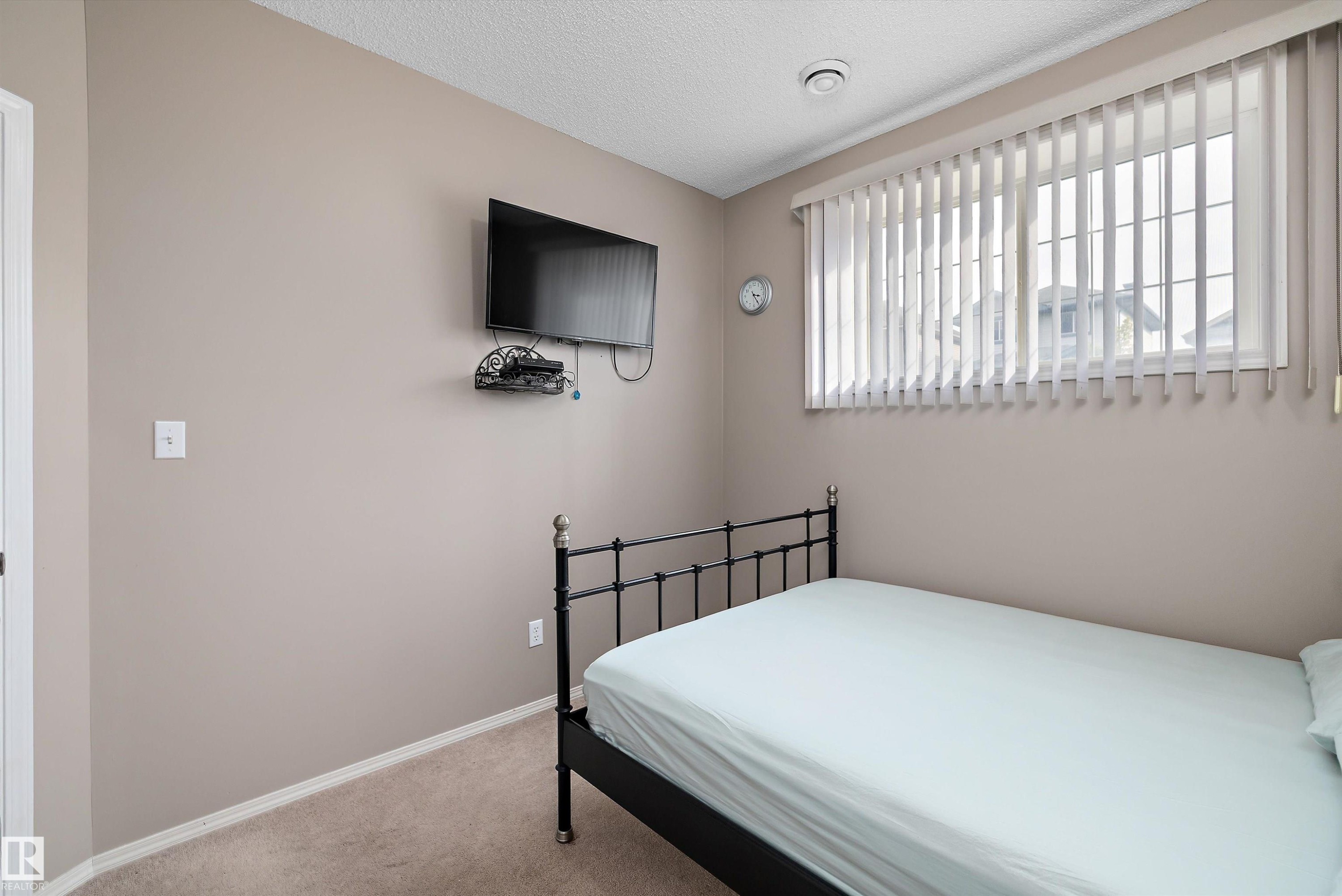 Carpeted flooring, window with vertical blinds, and neutral wall tones - 3114 32 Avenue Nw, Edmonton, AB