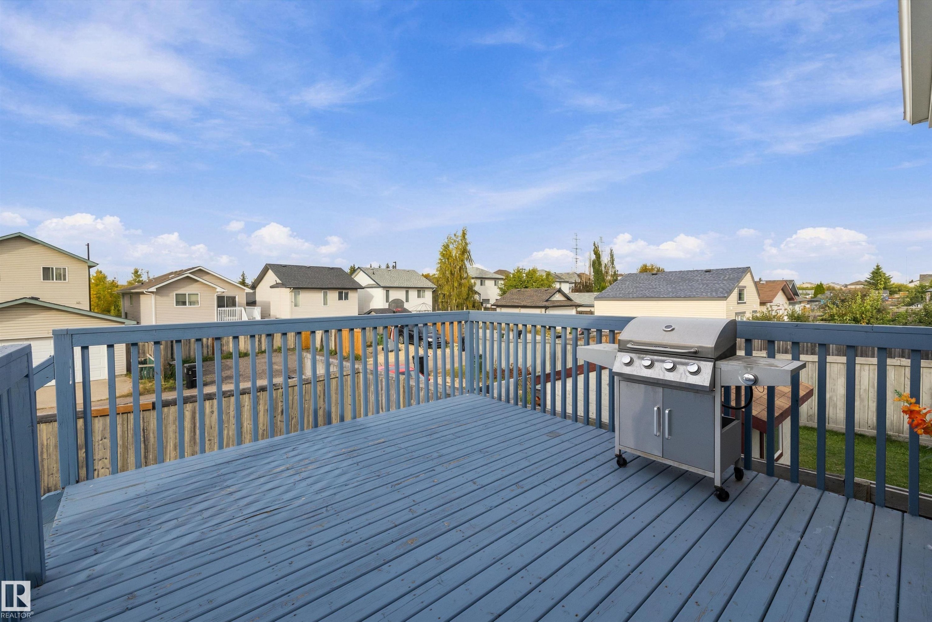 Expansive outdoor deck with painted wood flooring and railing - 3114 32 Avenue Nw, Edmonton, AB
