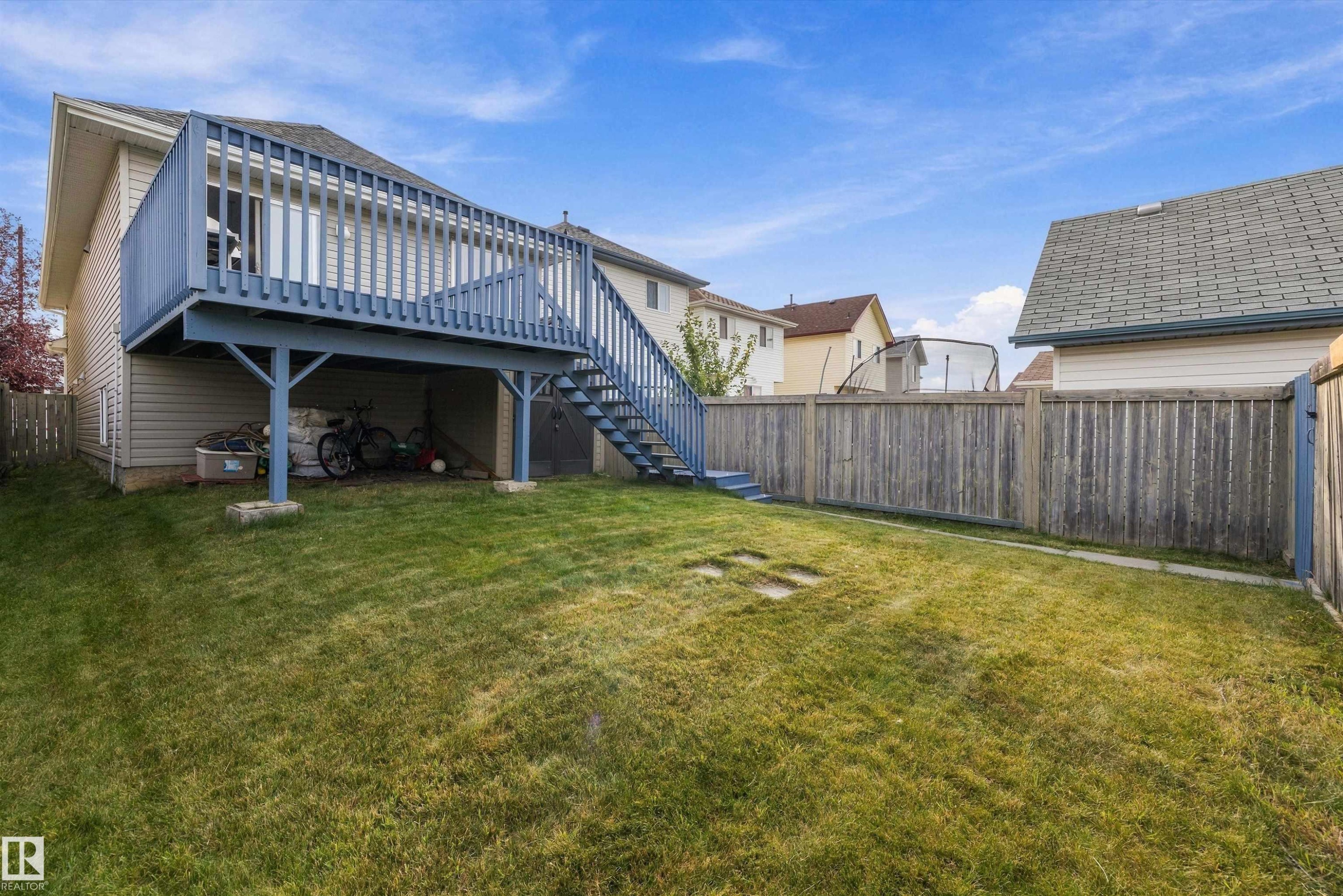 Expansive grassy yard with a multi-level deck and full perimeter fencing - 3114 32 Avenue Nw, Edmonton, AB