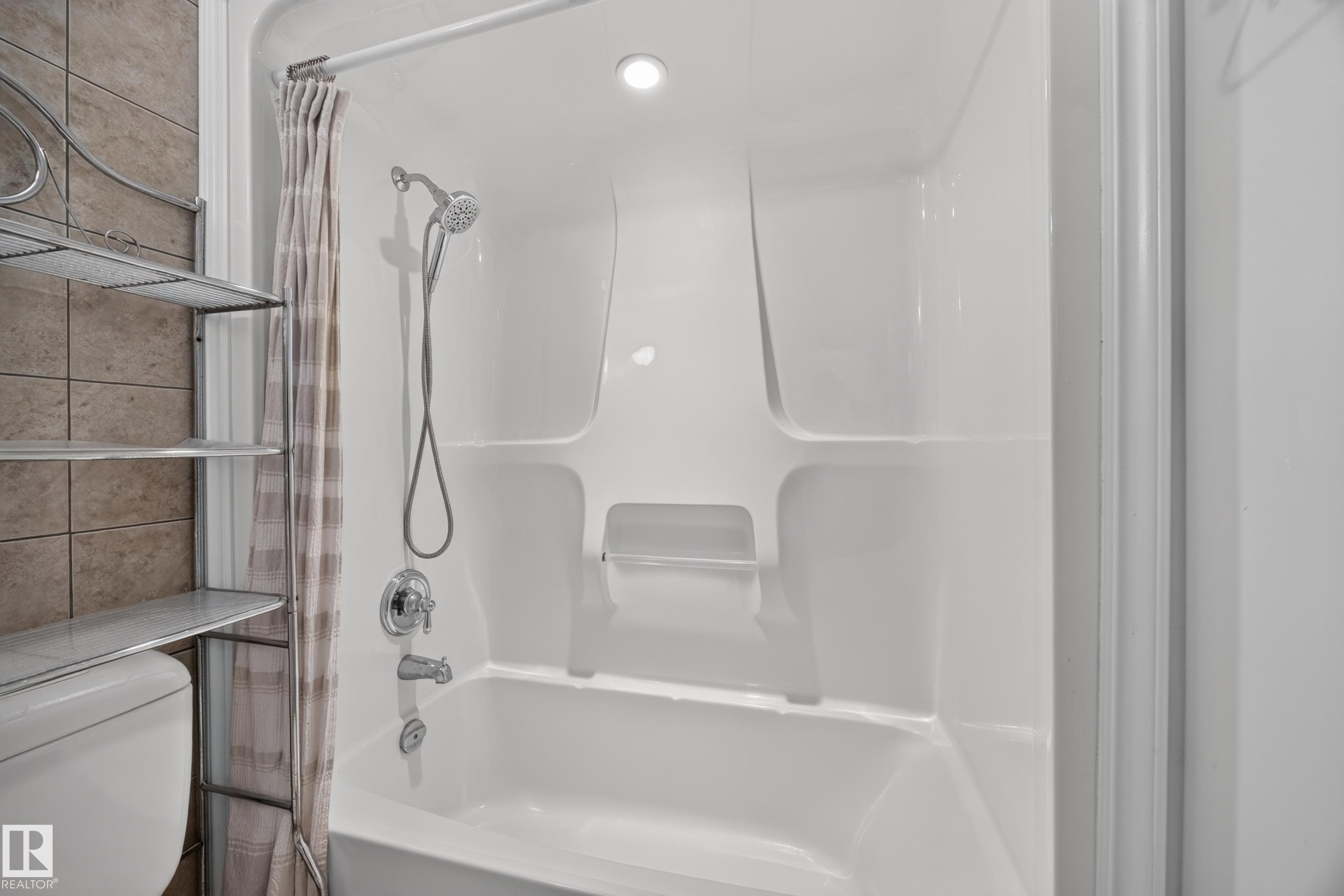 Integrated white fiberglass tub and shower enclosure with chrome fixtures - 9615 75 Avenue Nw, Edmonton, AB