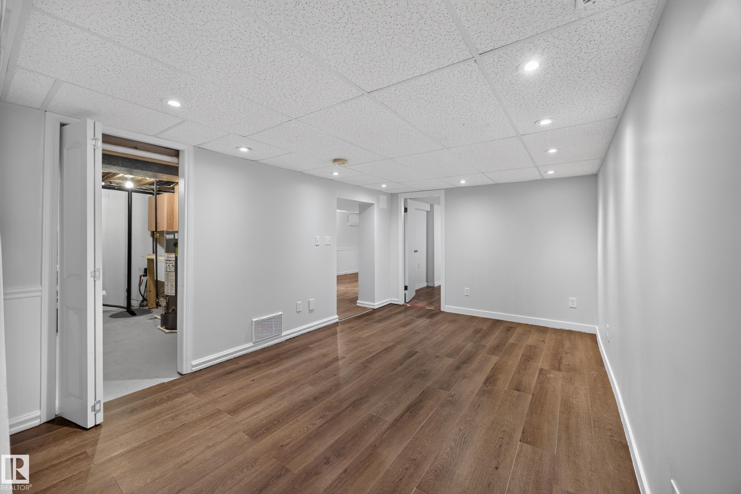 Wood-finish flooring, recessed lighting, drop ceiling, white trim, and light gray walls - 9615 75 Avenue Nw, Edmonton, AB