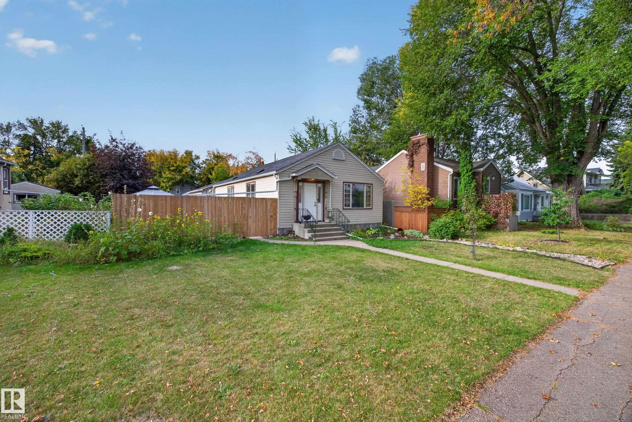 Single-story residence featuring light-colored siding and a dark-toned roof - 9615 75 Avenue Nw, Edmonton, AB