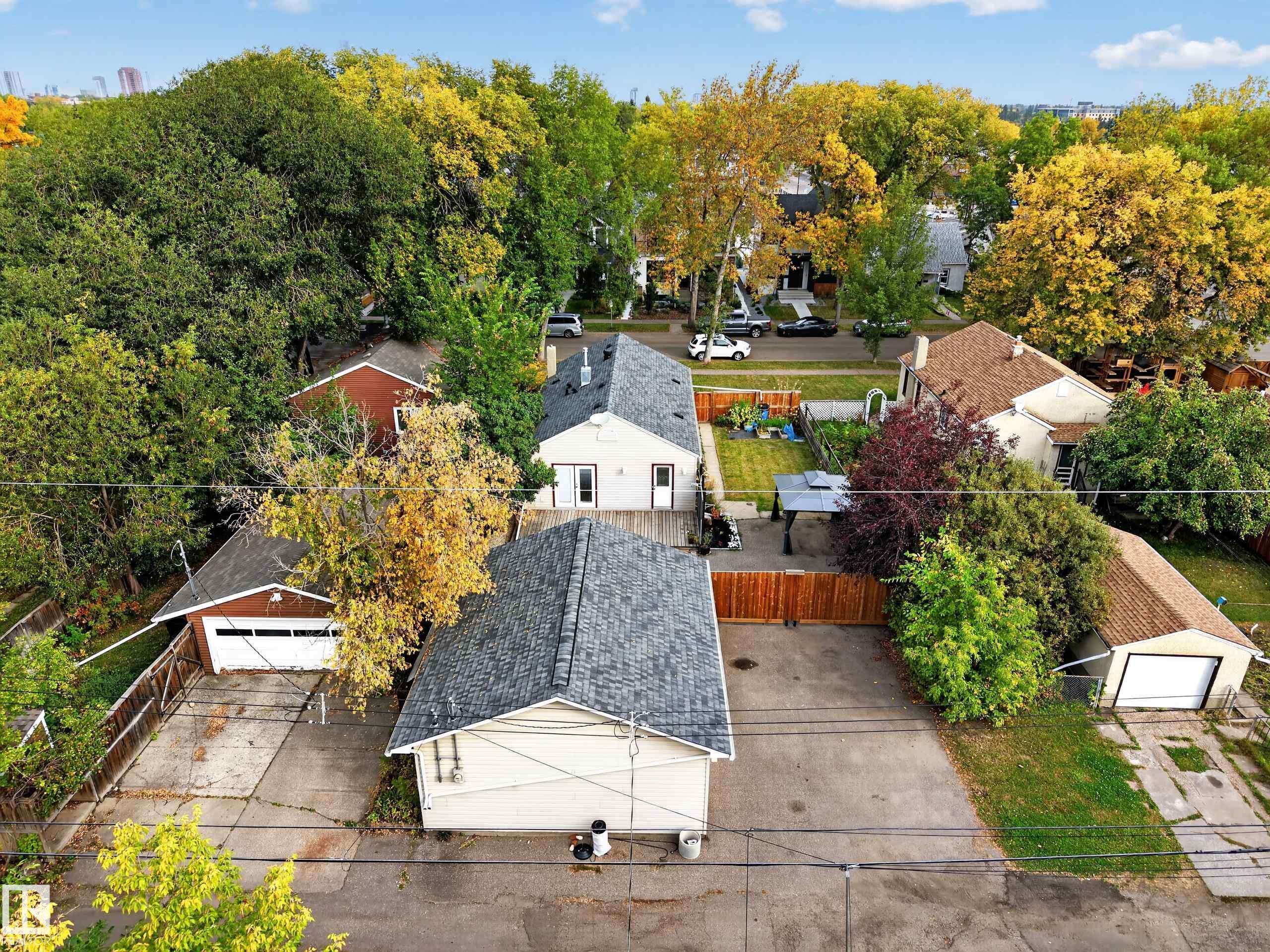 Expansive property with multiple detached garages, a spacious yard, and mature landscaping - 9615 75 Avenue Nw, Edmonton, AB