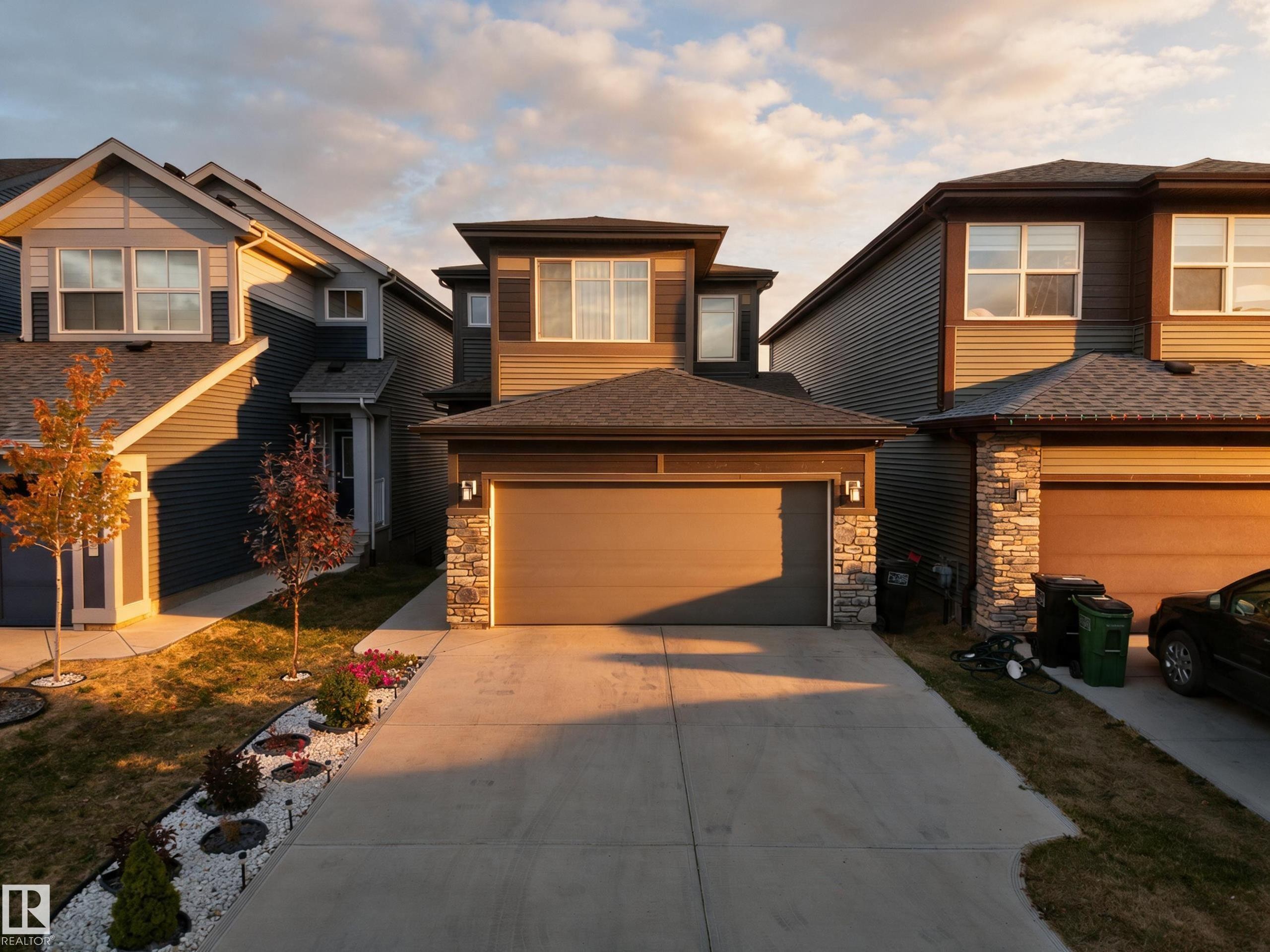 Two-story exterior with horizontal siding and stone accents - 4104 3 Avenue Sw, Edmonton, AB