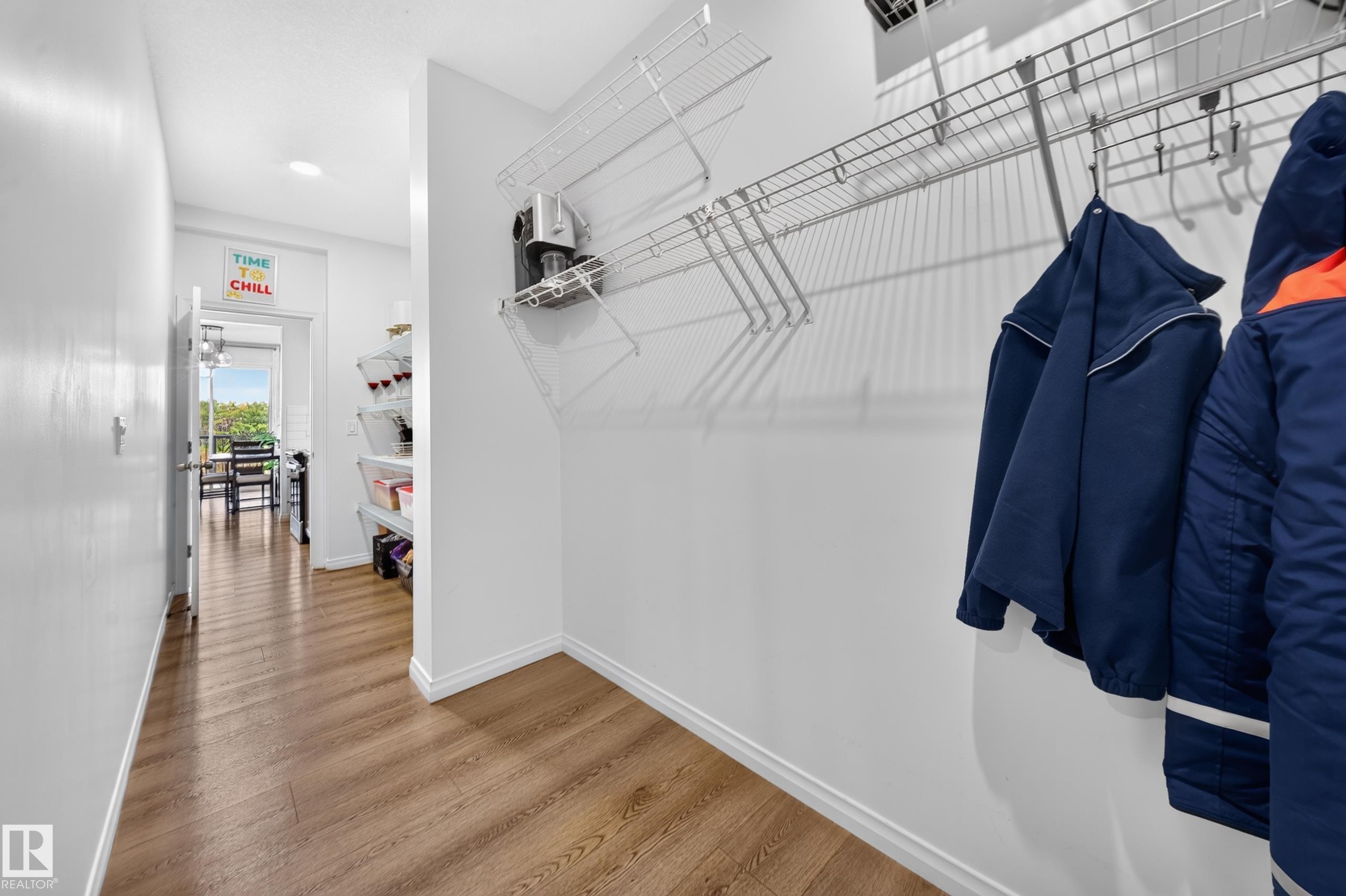 Wood-finish flooring throughout, white baseboards, and wire shelving storage system - 4104 3 Avenue Sw, Edmonton, AB