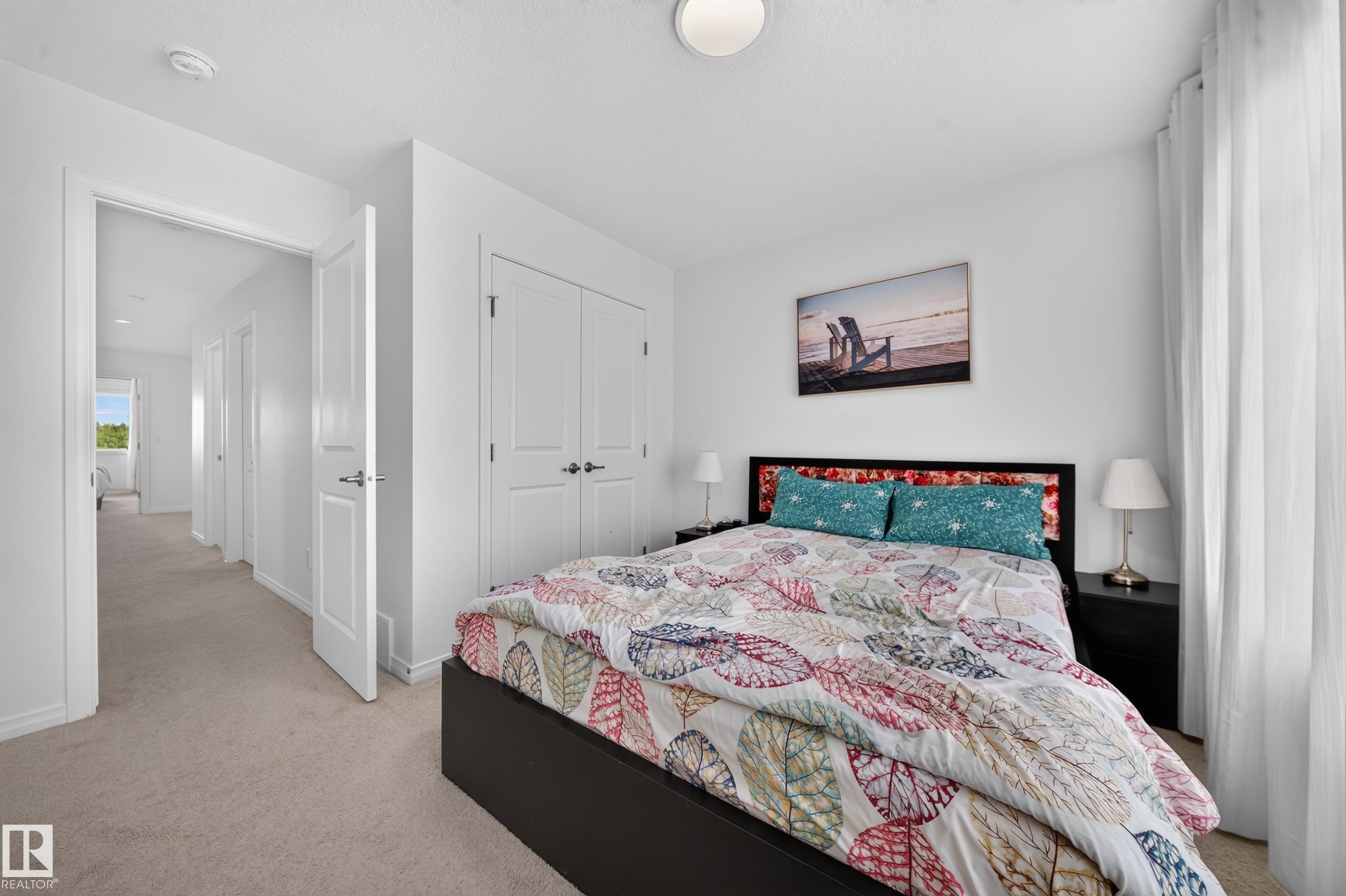 White interior walls, neutral carpet flooring, recessed ceiling lighting, and a double-door closet - 4104 3 Avenue Sw, Edmonton, AB