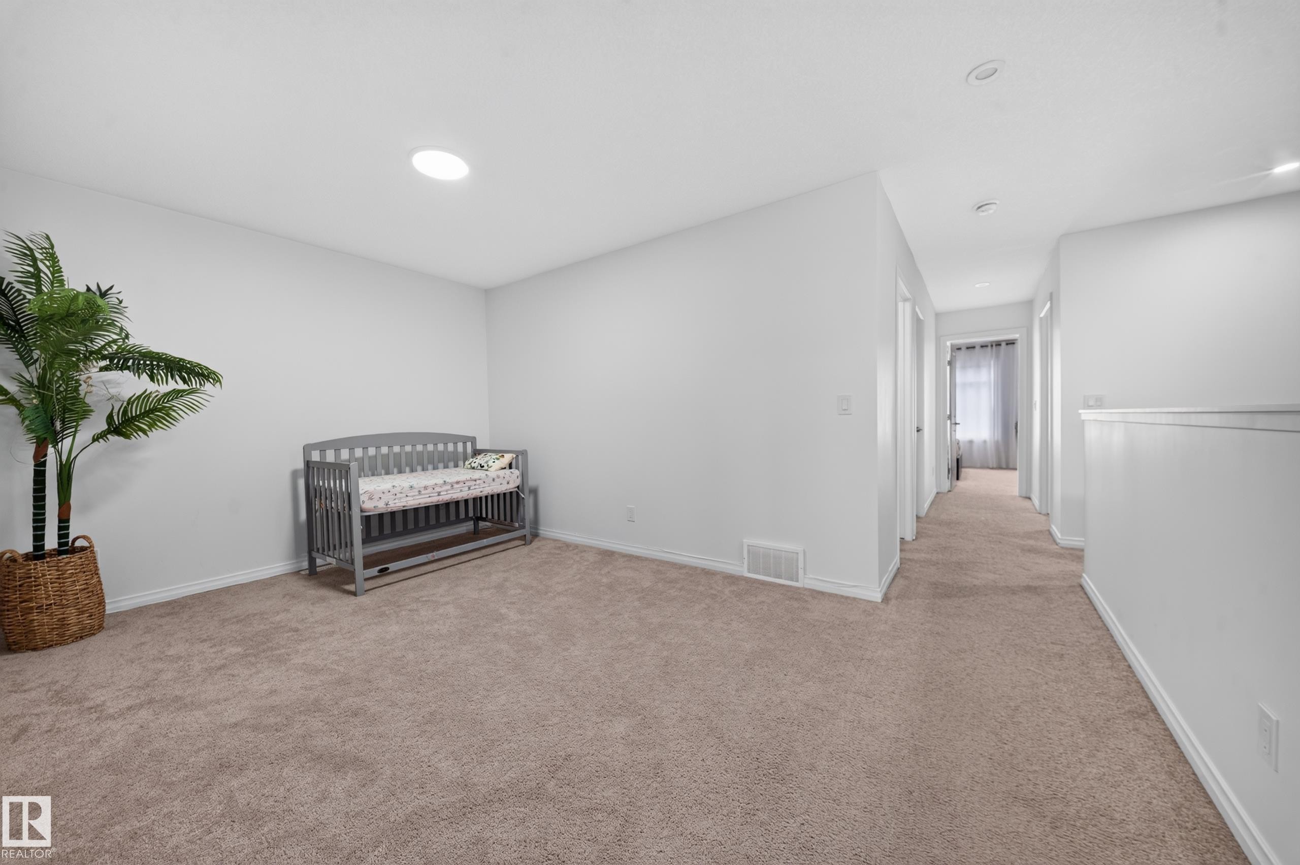 Carpeted room with white walls, recessed lighting, and a solar tube skylight - 4104 3 Avenue Sw, Edmonton, AB